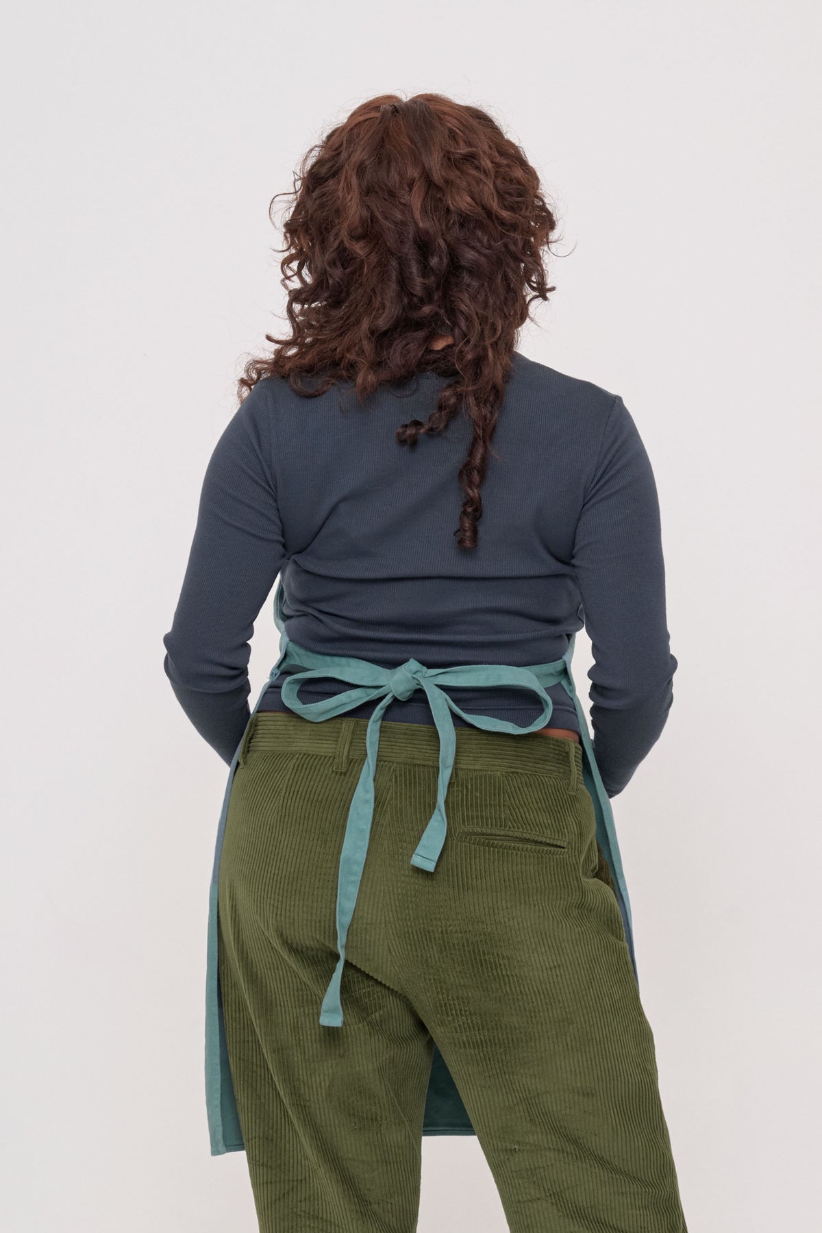 Adjustable Apron in Oyster – back view on model, waist strap tied