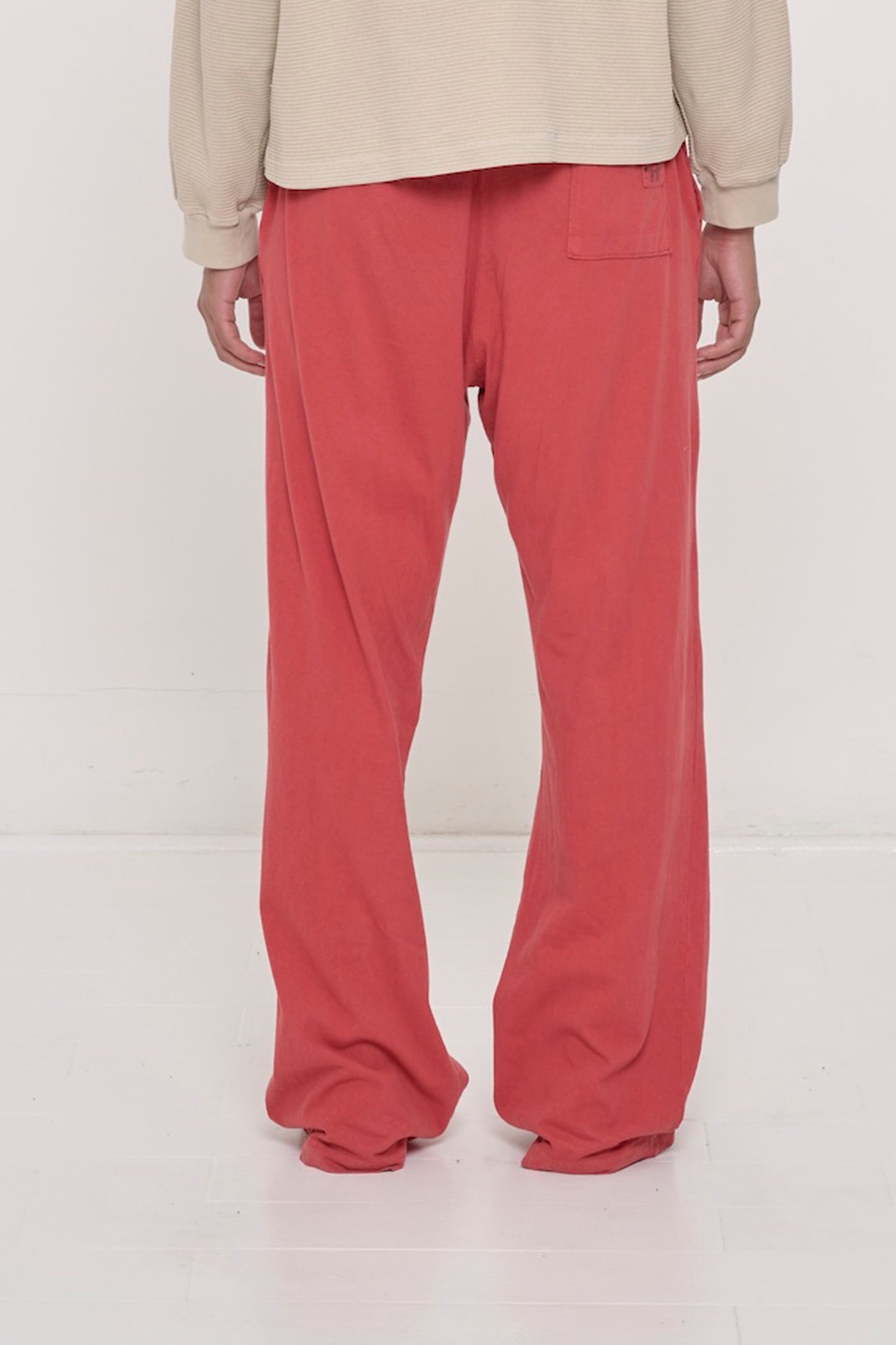Close-up back view of a person wearing Jerico's Apartment Pants in Cedar, highlighting the back pocket.
