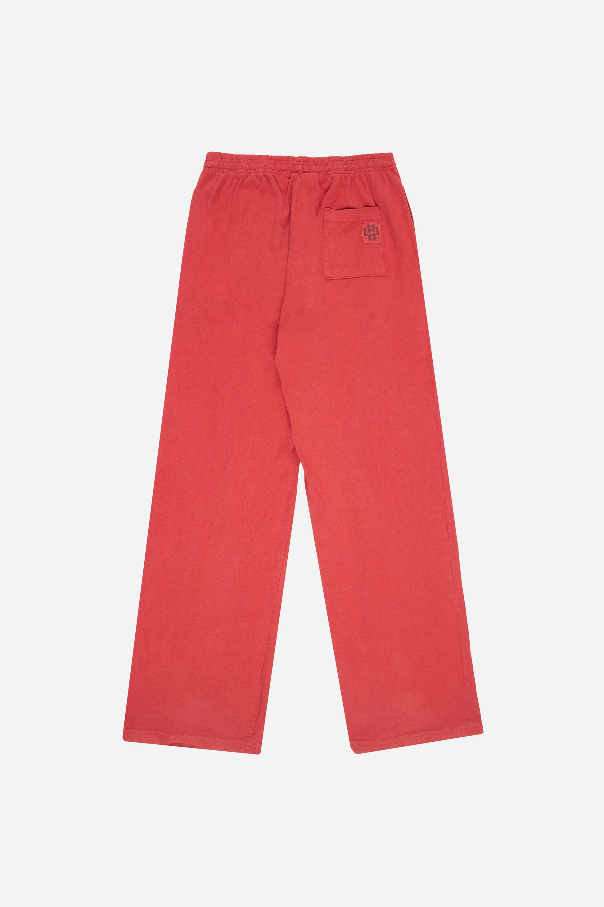 Flat lay of Jerico's Apartment Pants in Cedar red, showing the back of the leg and the pocket detail.