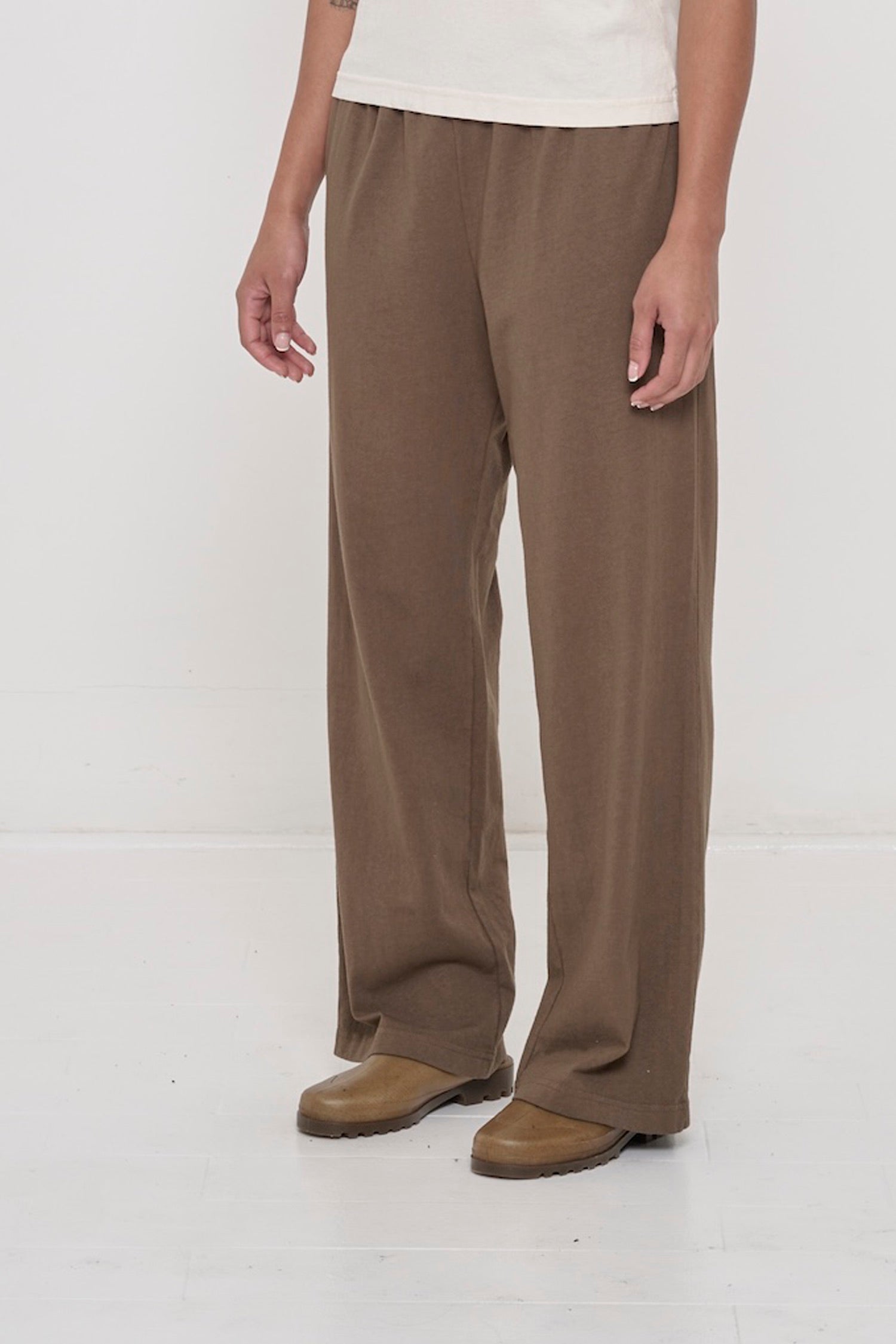 Person facing 45-degrees to the front in Dry Soil Apartment Pants, showing inseam and outseam.