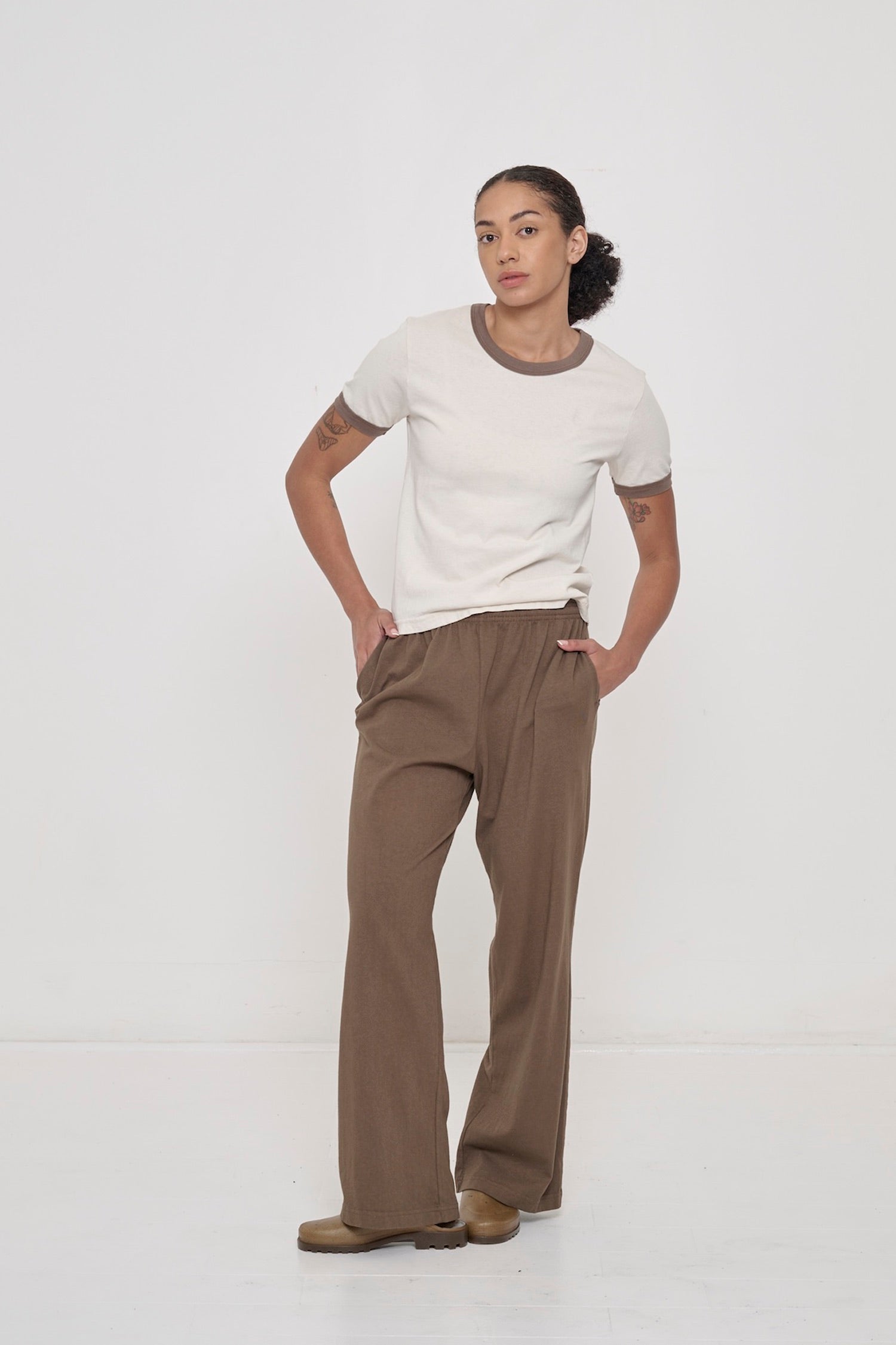 A woman wearing Jerico's Apartment Pants in Dry Soil and the matching Ringer Trash Tee in Dry Soil. 