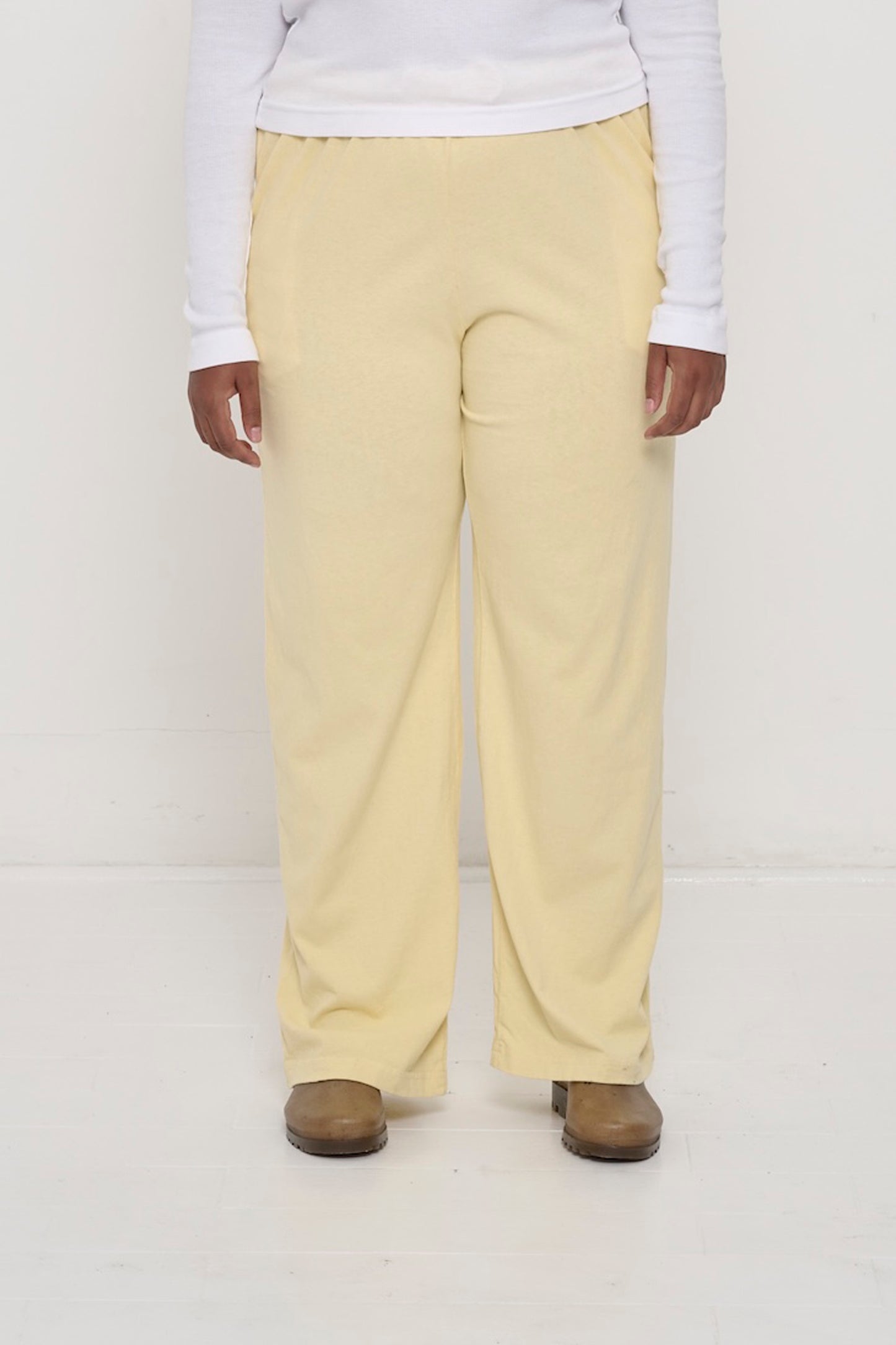 Waist down of a 5'8"person in Size XL French Butter Apartment Pants. Relaxed drape. Hem at bottom of the heels.
