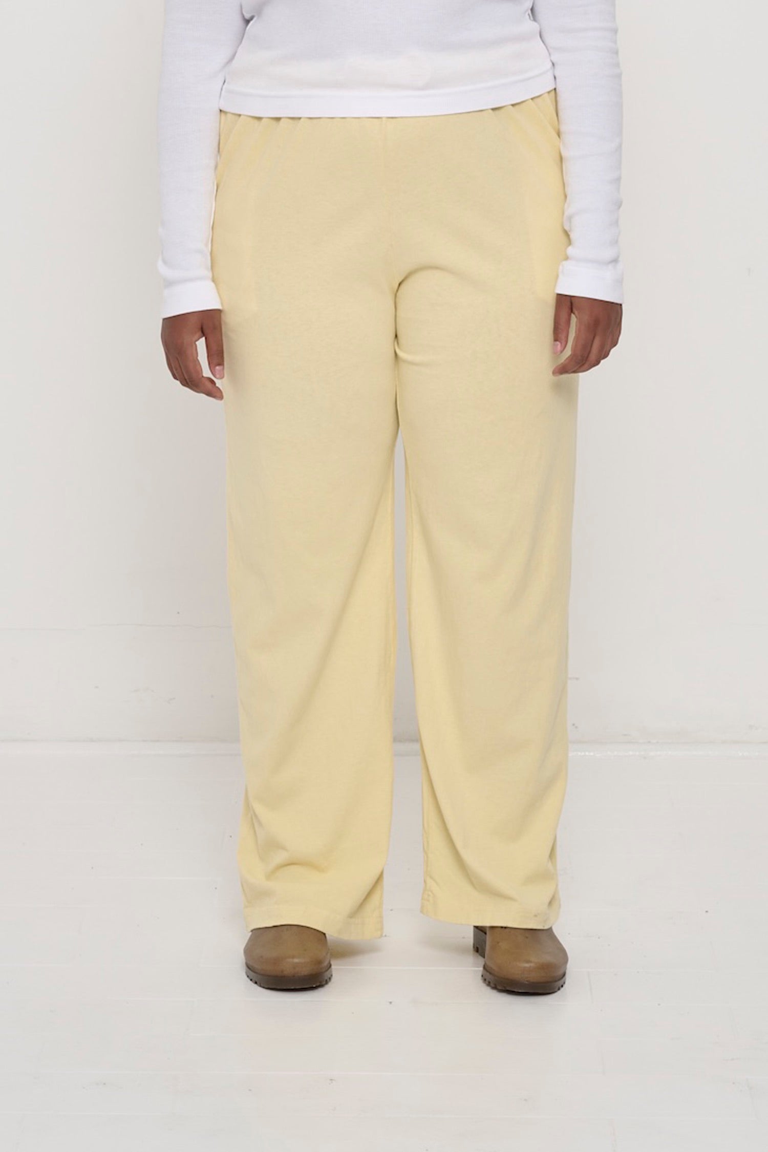 Waist down of a 5'8"person in Size XL French Butter Apartment Pants. Relaxed drape. Hem at bottom of the heels.