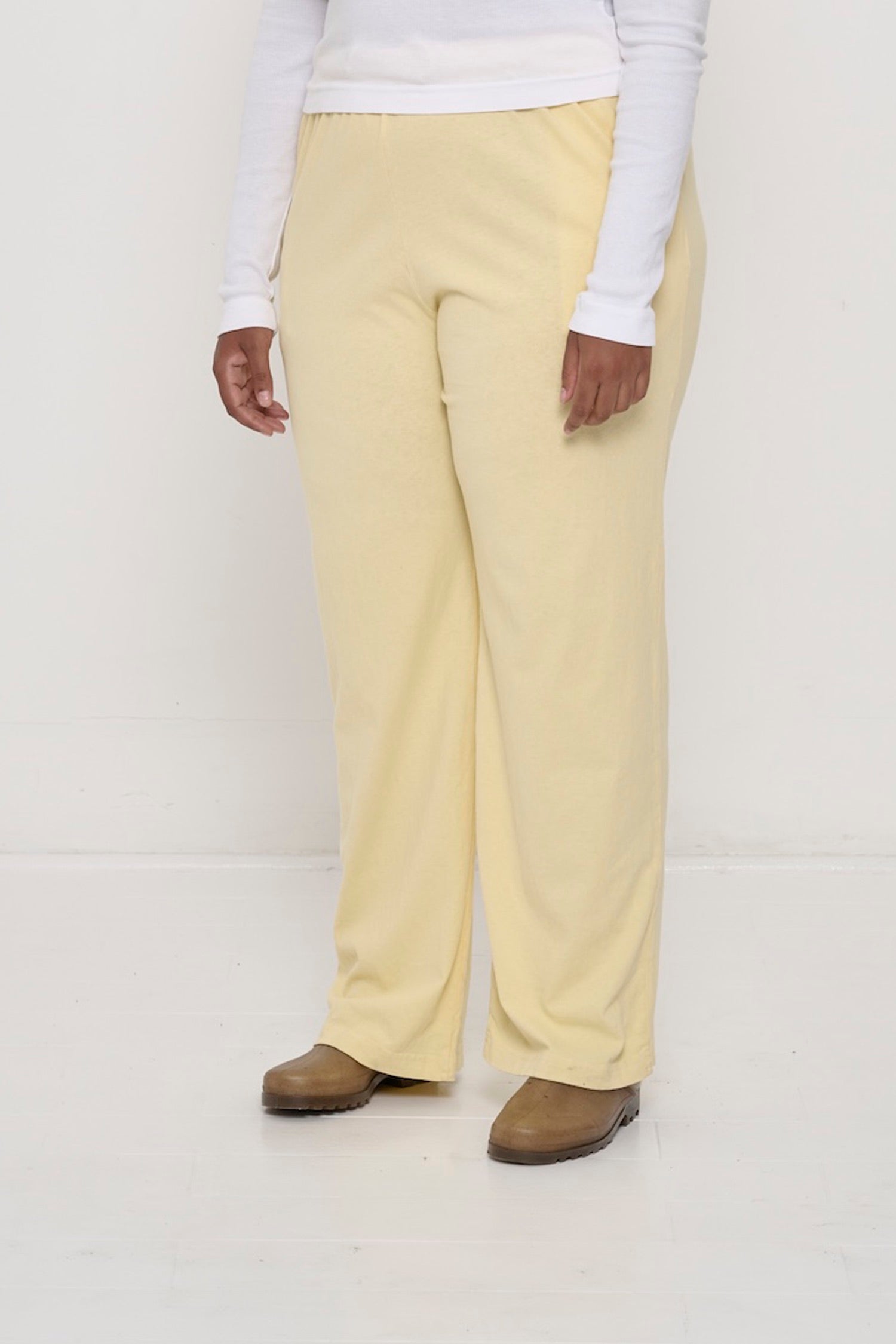 French Butter Apartment Pants on a person, 45-degree angle from the front, waist down, showing hem, inseam, and outseam.
