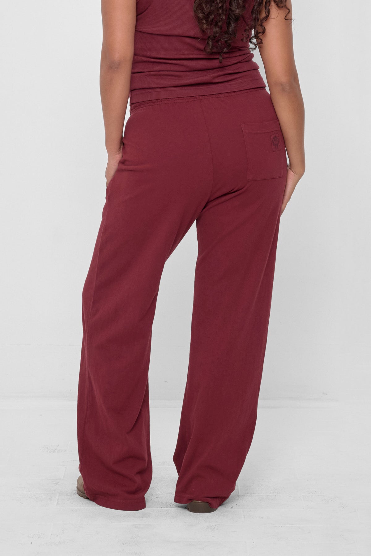 Apartment Pants in Garnet – back view on model