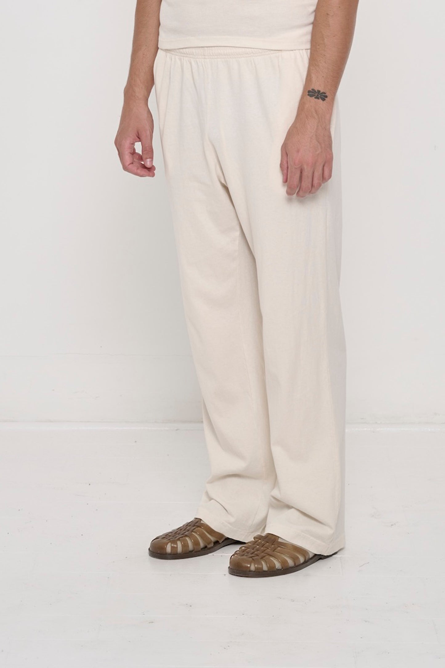 Scour Apartment Pants on a person, 45-degree angle from the front, waist down. Shows inseam, outseam and floor skimming hem.