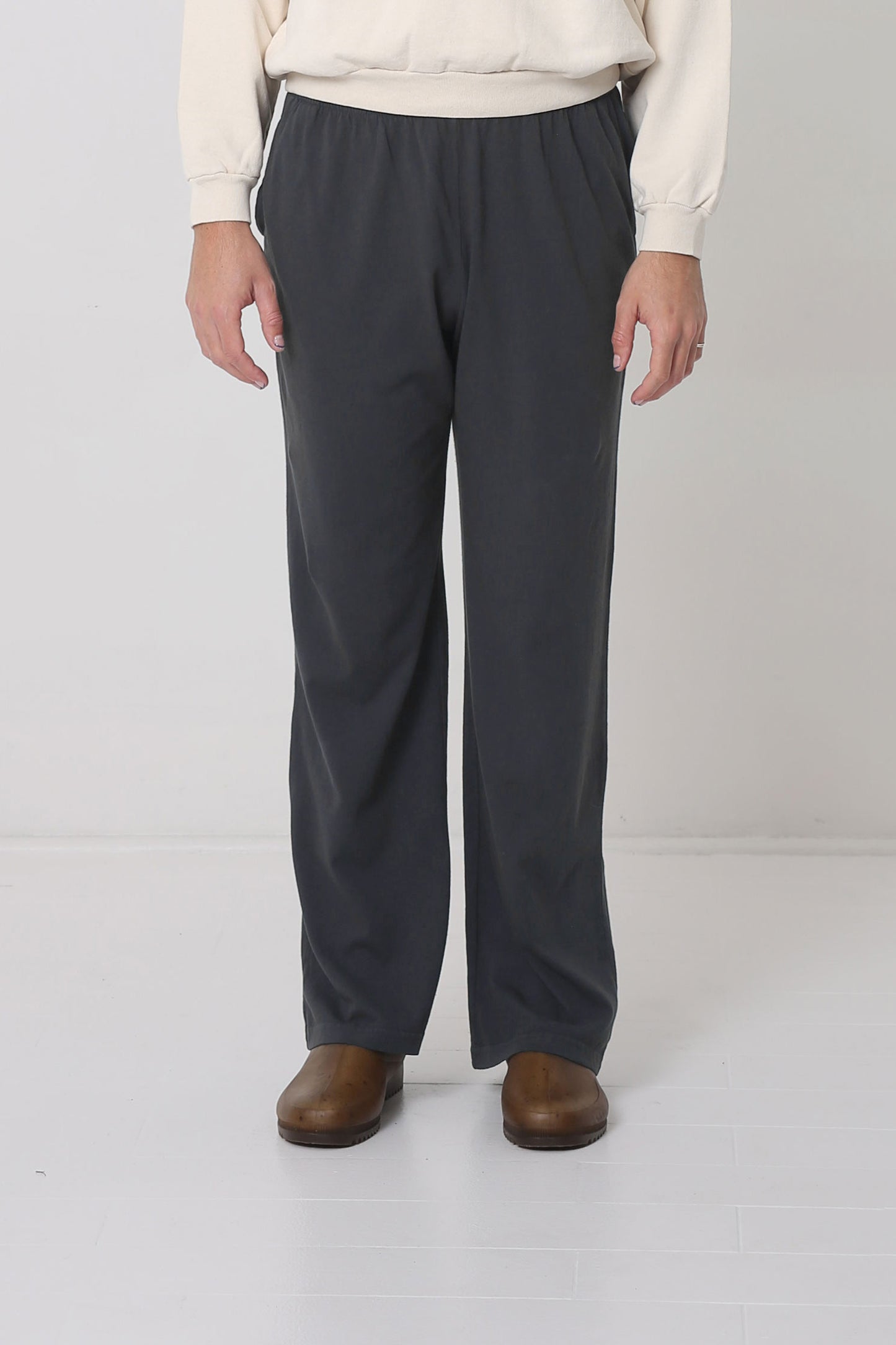 Waist down of a 6' person in Size L Slate Apartment Pants. Hem ends at the heel.