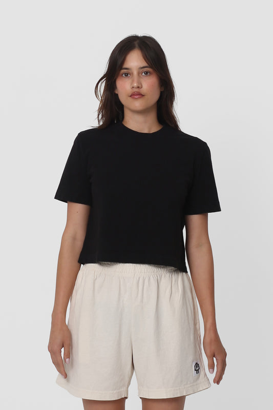 5'5" woman in a size S Black Baby Trash Tee. Hem ends at her upper hip.