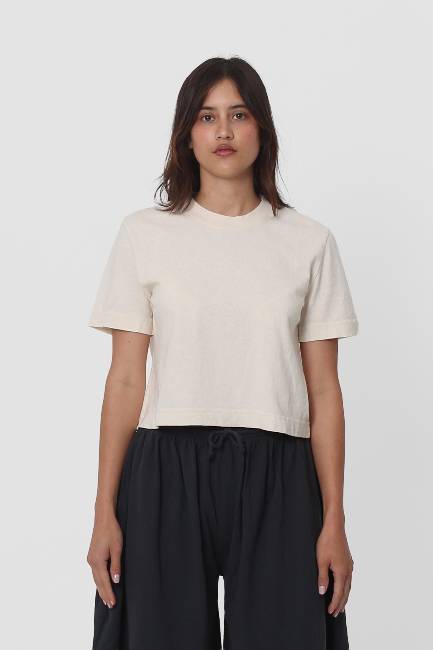 5'5" woman in a size S Scour Baby Trash Tee. Hem ends at her upper hip.