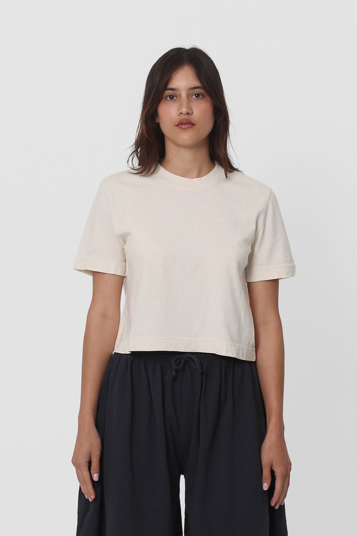 5'5" woman in a size S Scour Baby Trash Tee. Hem ends at her upper hip.