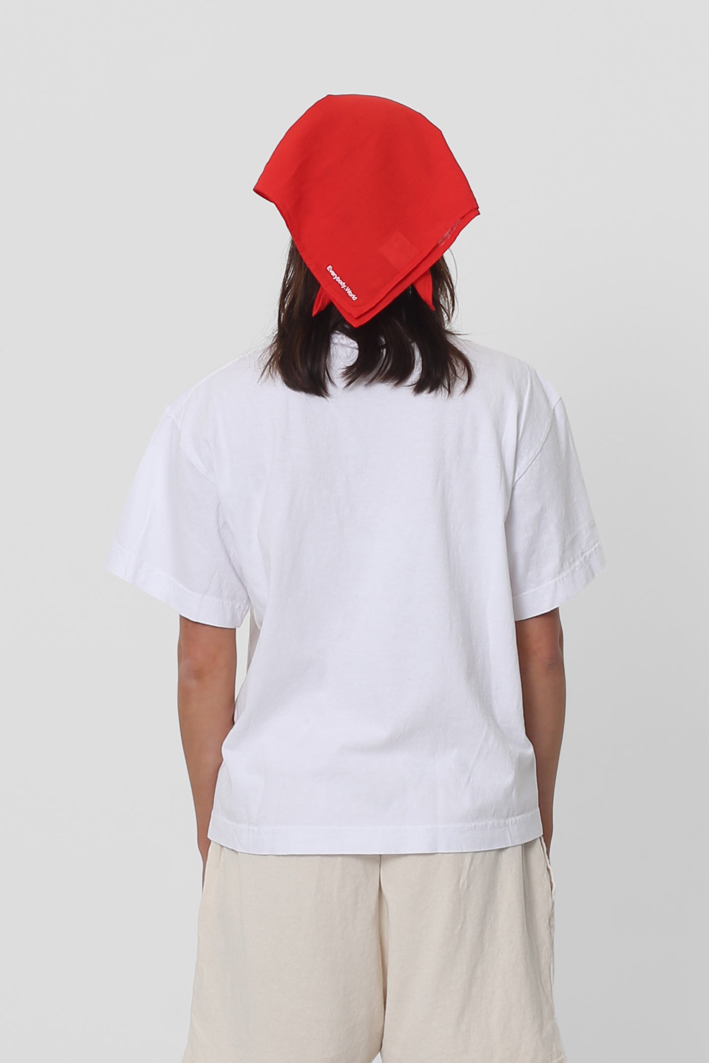 Person wearing Bandana Scarf in Lava tied around hair, viewed from the back.