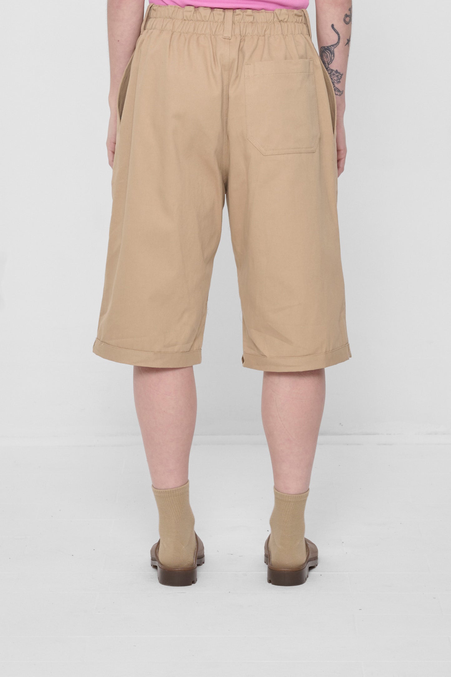 Back view showing large patch pocket centered on the model's right rear.