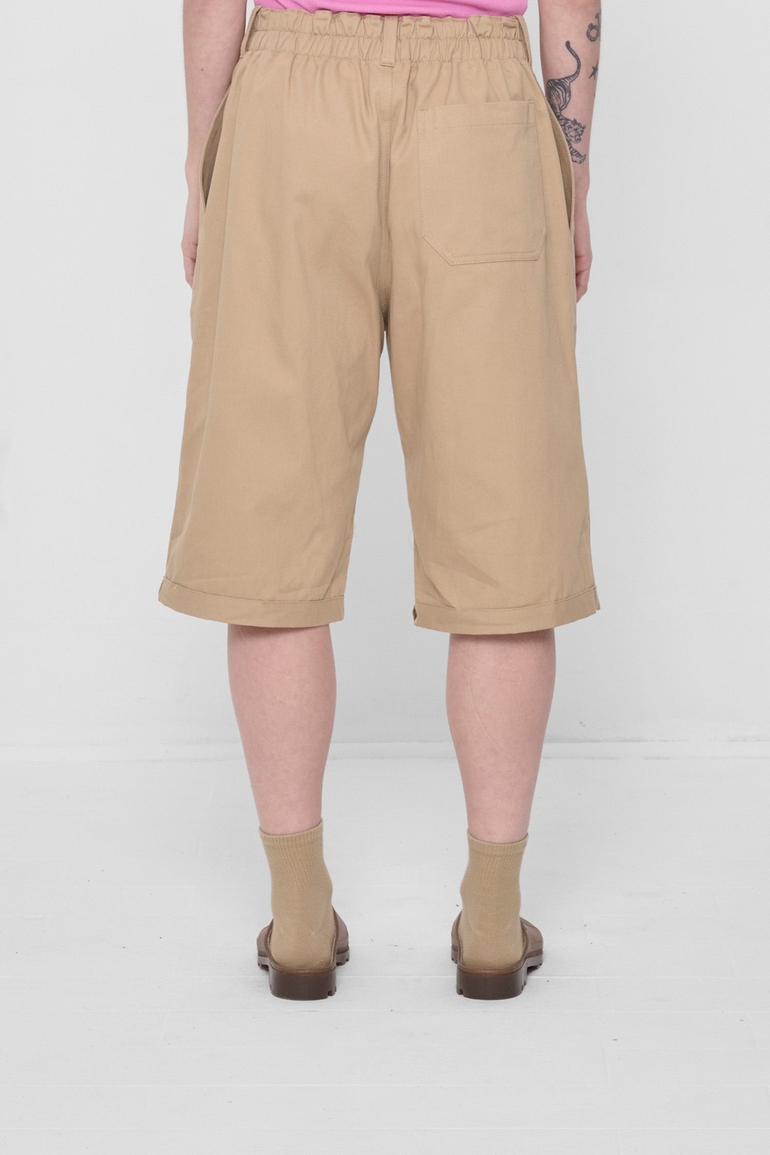 Back view showing large patch pocket centered on the model's right rear.