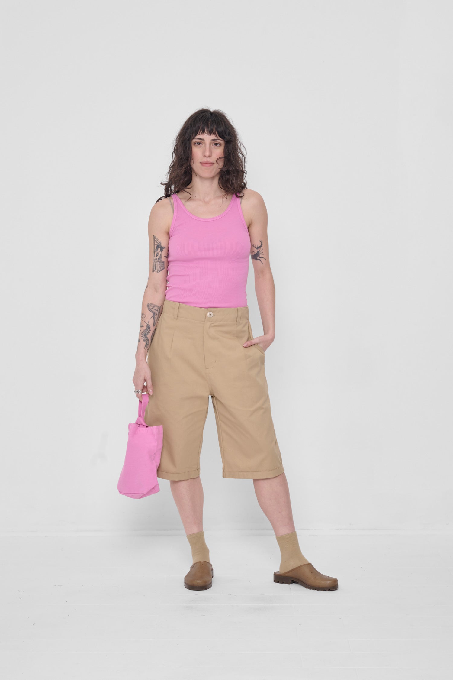 Hand in side pocket. Styled with Pixie Rib Tank and holding a Loop Tote in her other hand.