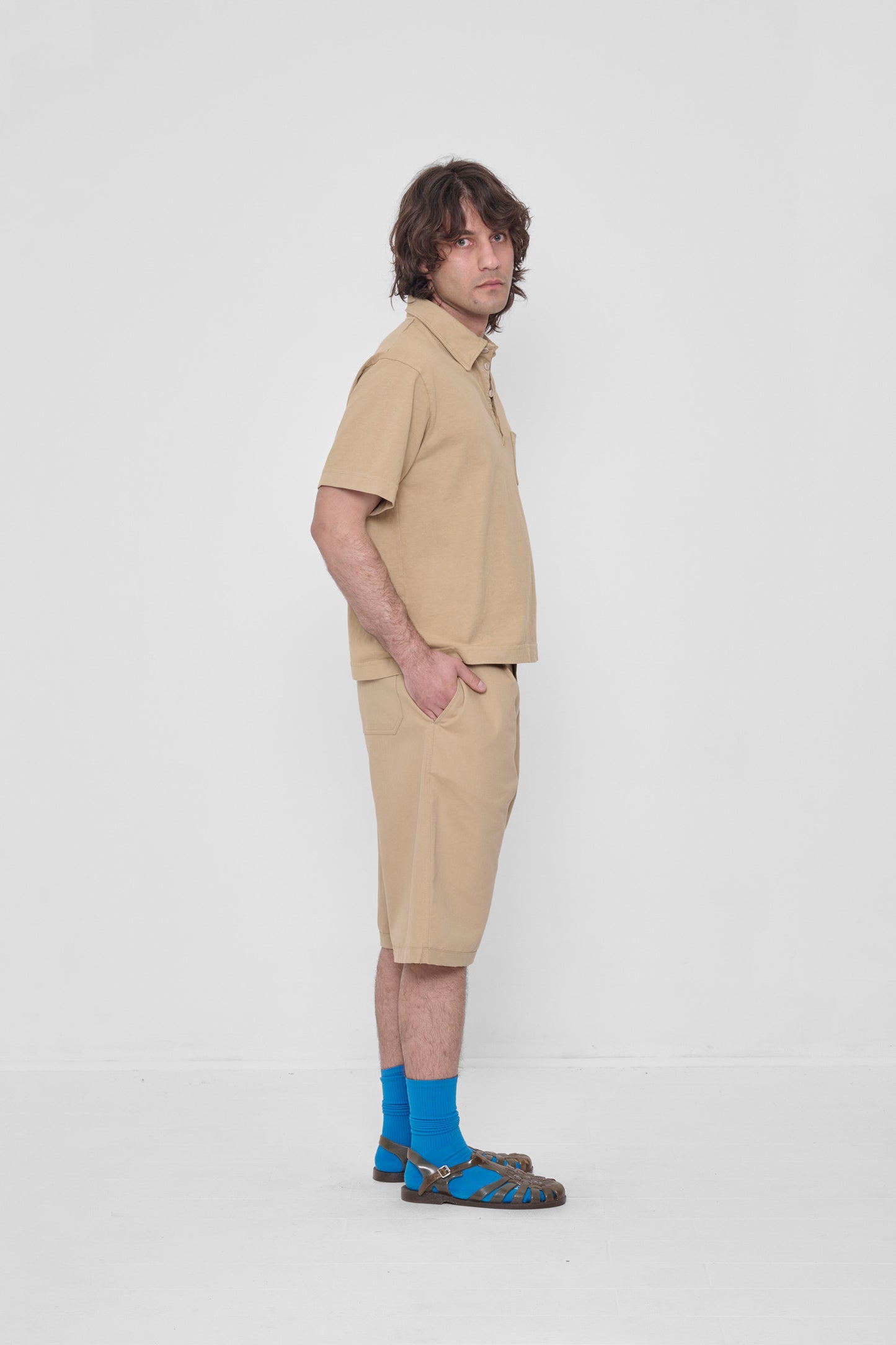 Hands in side pockets. Styled with matching Trash Polo, Lapis Squishy Socks and Plasticana sandals.