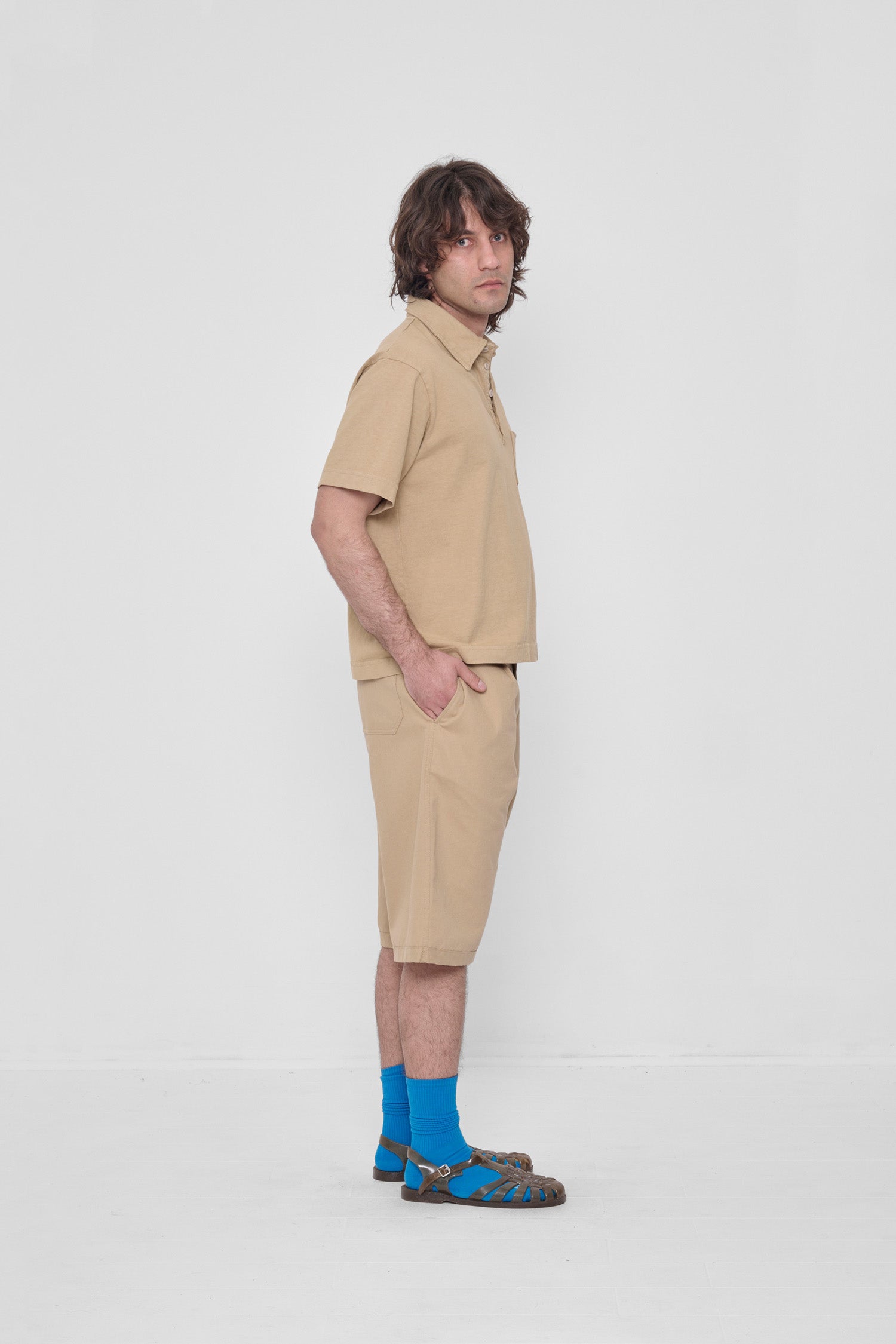 Hands in side pockets. Styled with matching Trash Polo, Lapis Squishy Socks and Plasticana sandals.