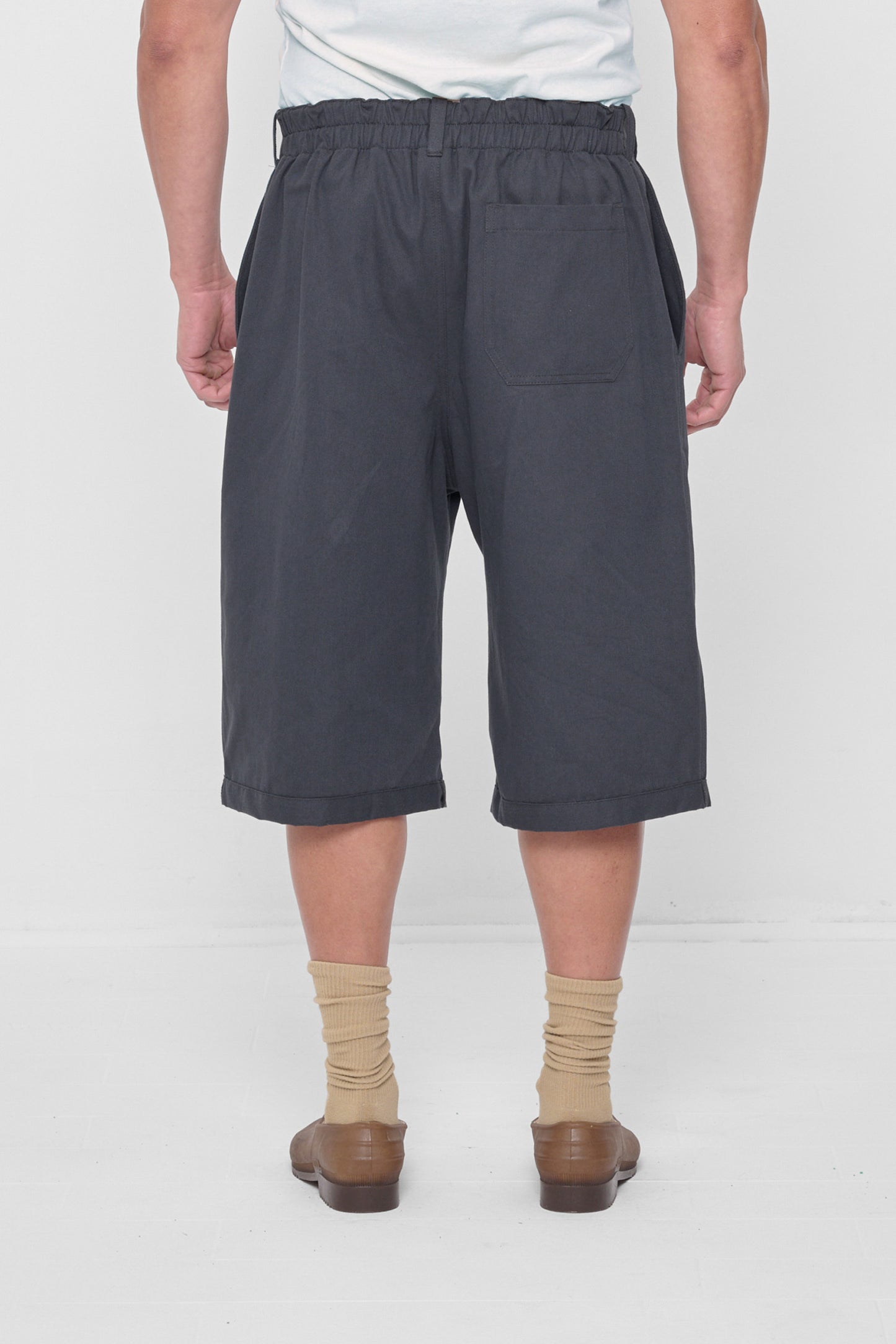 Back view showing large patch pocket centered on the model's right rear.