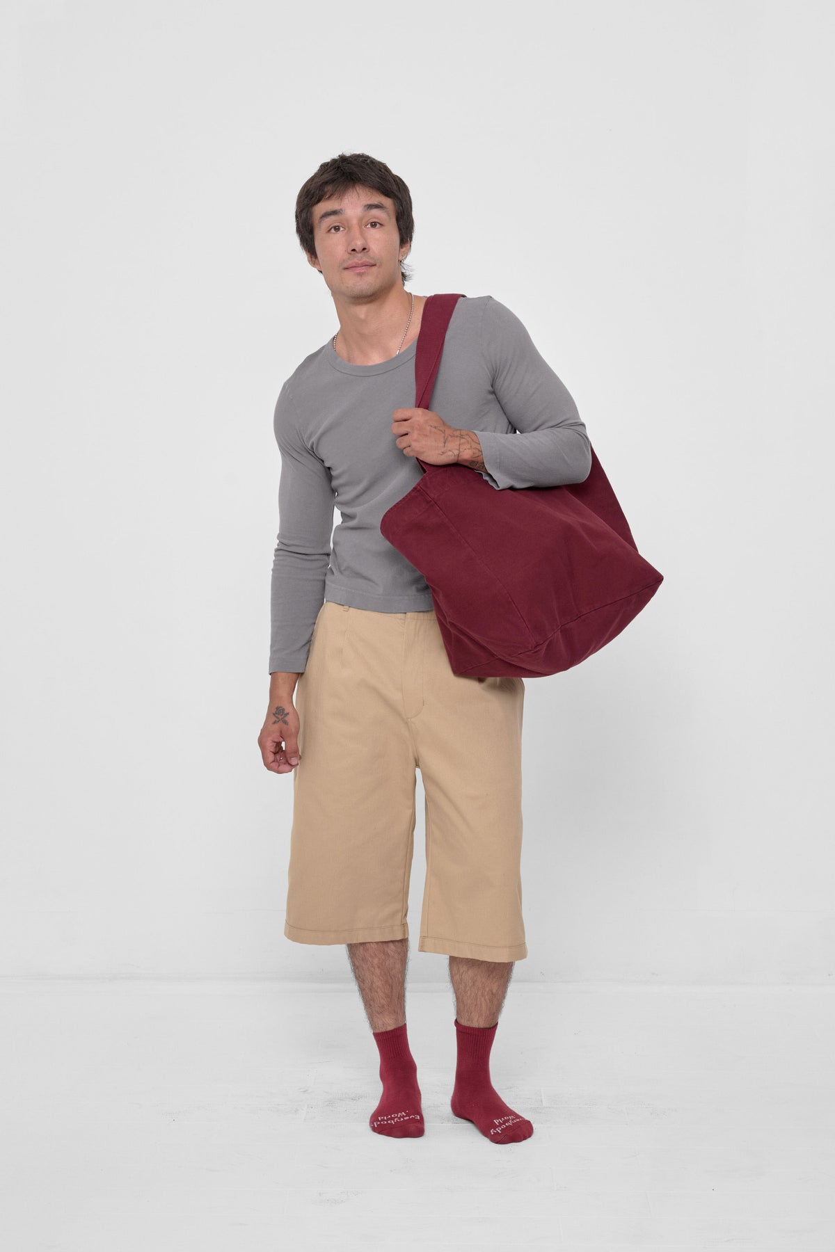 Big Tote in Garnet – carried on model's shoulder, full-body view showing scale.