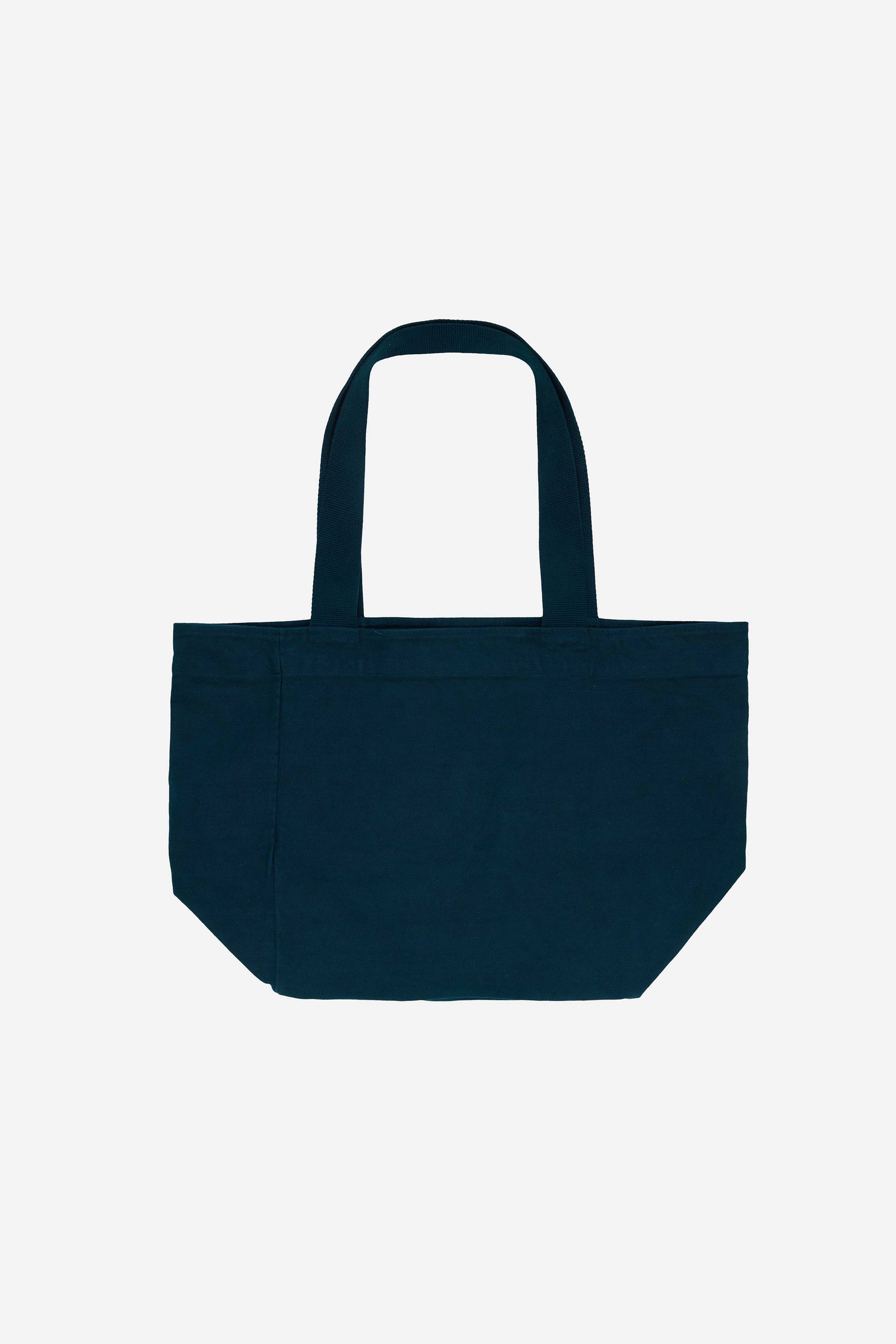 Flat lay of Big Tote in Juniper dark teal, showing depth, stitching, and web straps.