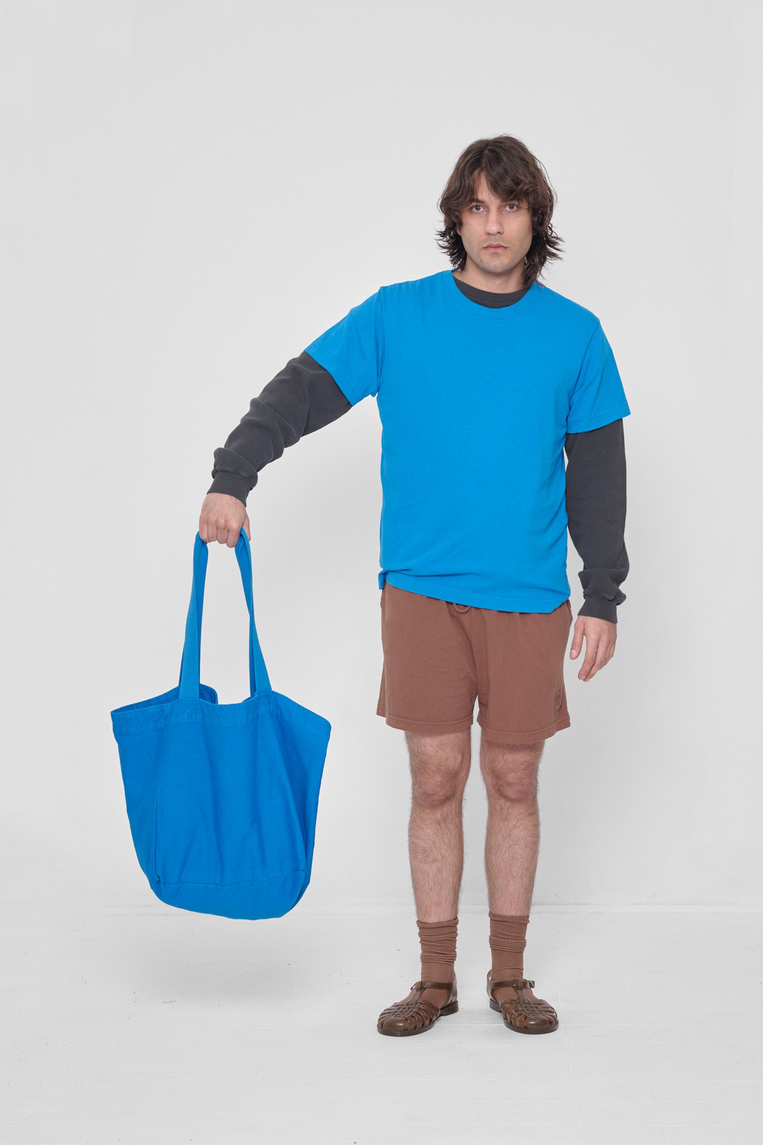 Man holding Big Tote to his side showing how large it is. 
