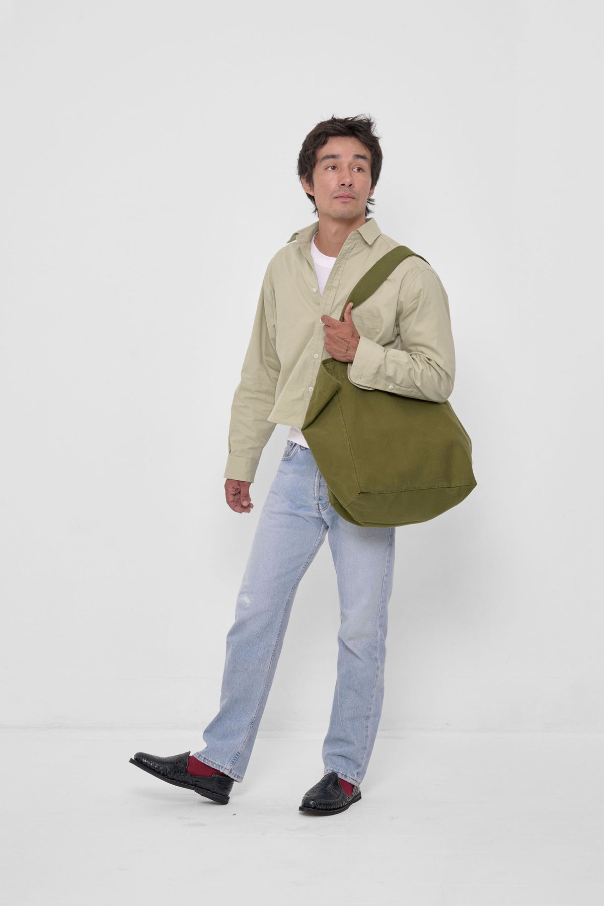 Big Tote in Olive – carried on model's shoulder, full-body 3/4 front view showing scale.