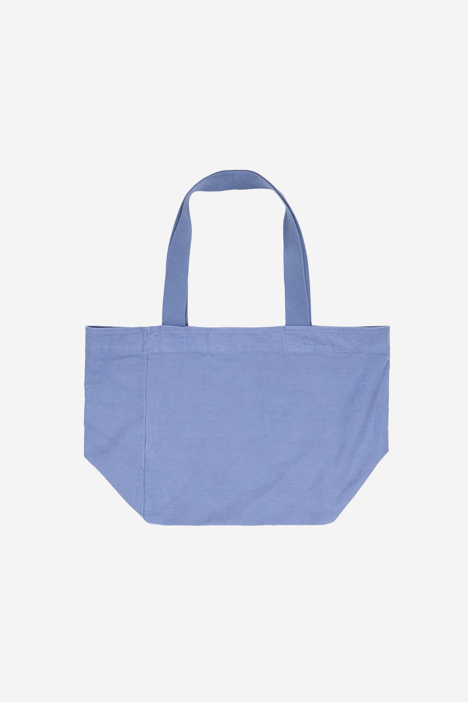 Flat lay of Big Tote in Periwinkle light blue-purple, showing depth, stitching, and web straps.