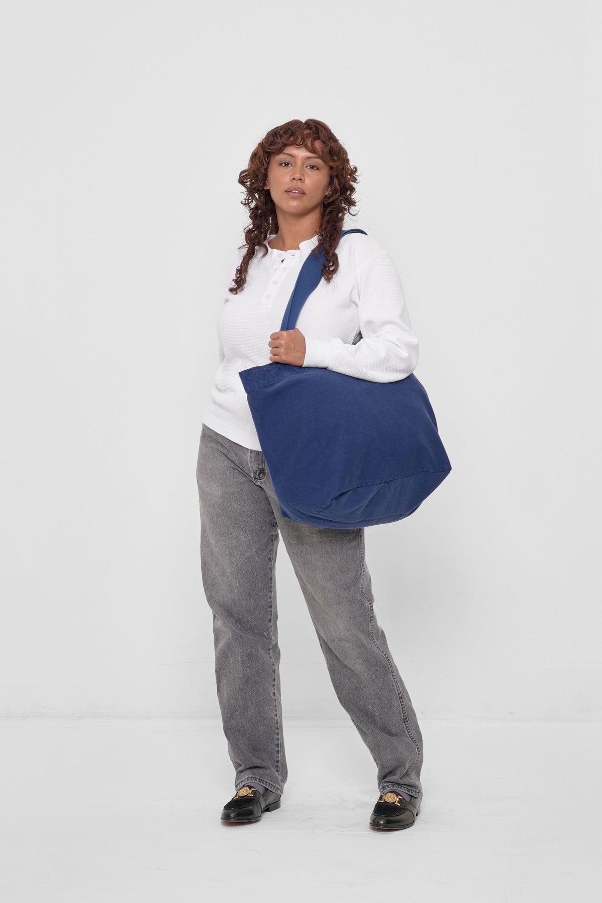 Big Tote in Washed Navy – carried on model's shoulder, full-body view showing scale.