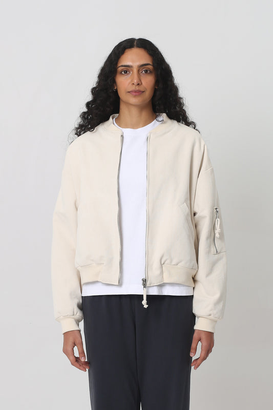 5'10" woman in the Biodegradable Bomber Jacket in Natural. Hem hits her upper middle hip.