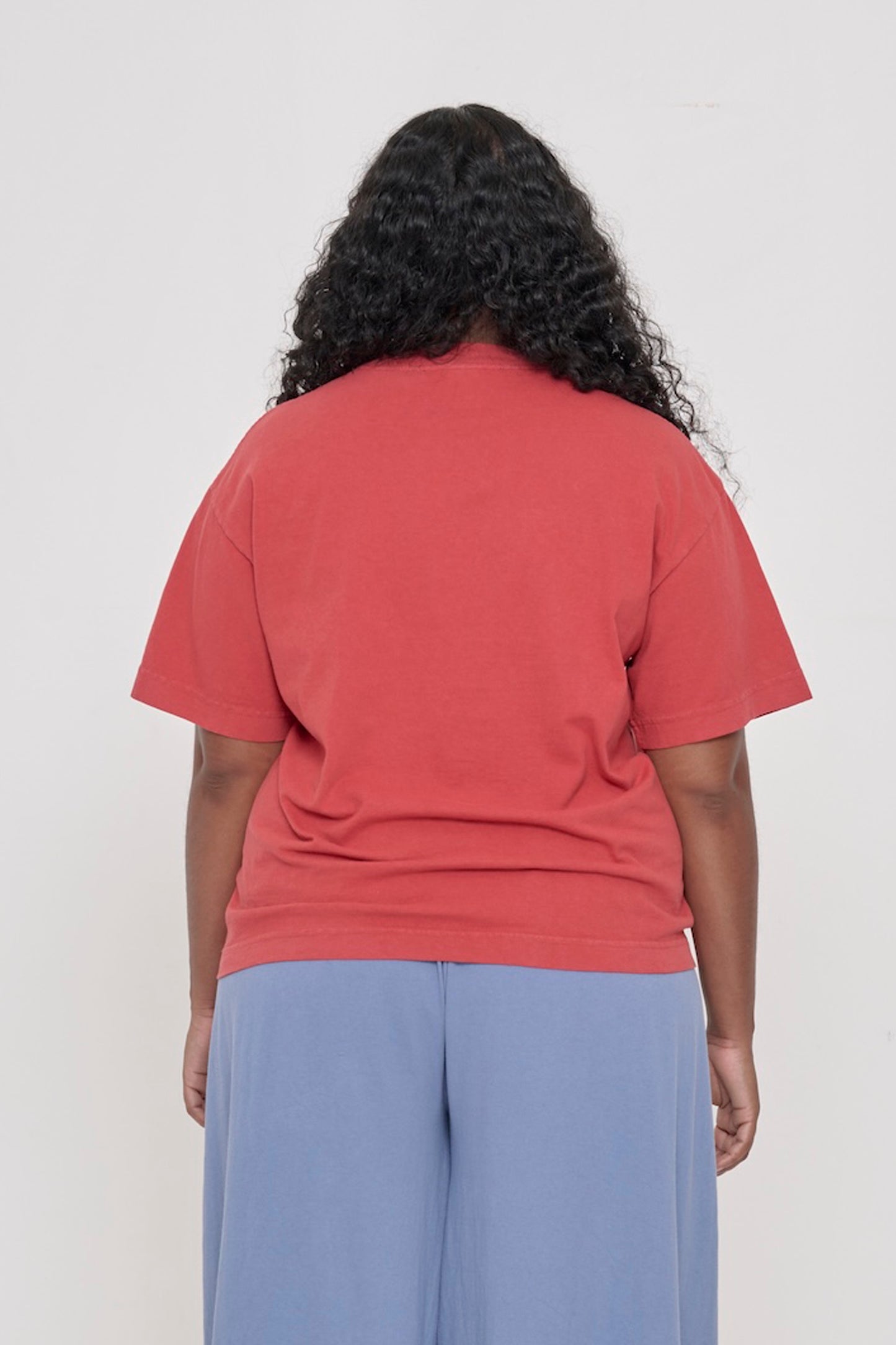 Back view: a woman in a Cedar Boxier Trash Tee showing fabric drape and relaxed fit throughout.