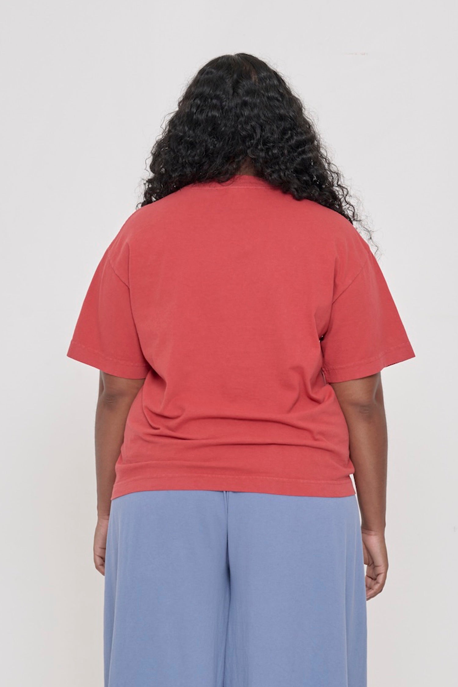 Back view: a woman in a Cedar Boxier Trash Tee showing fabric drape and relaxed fit throughout.