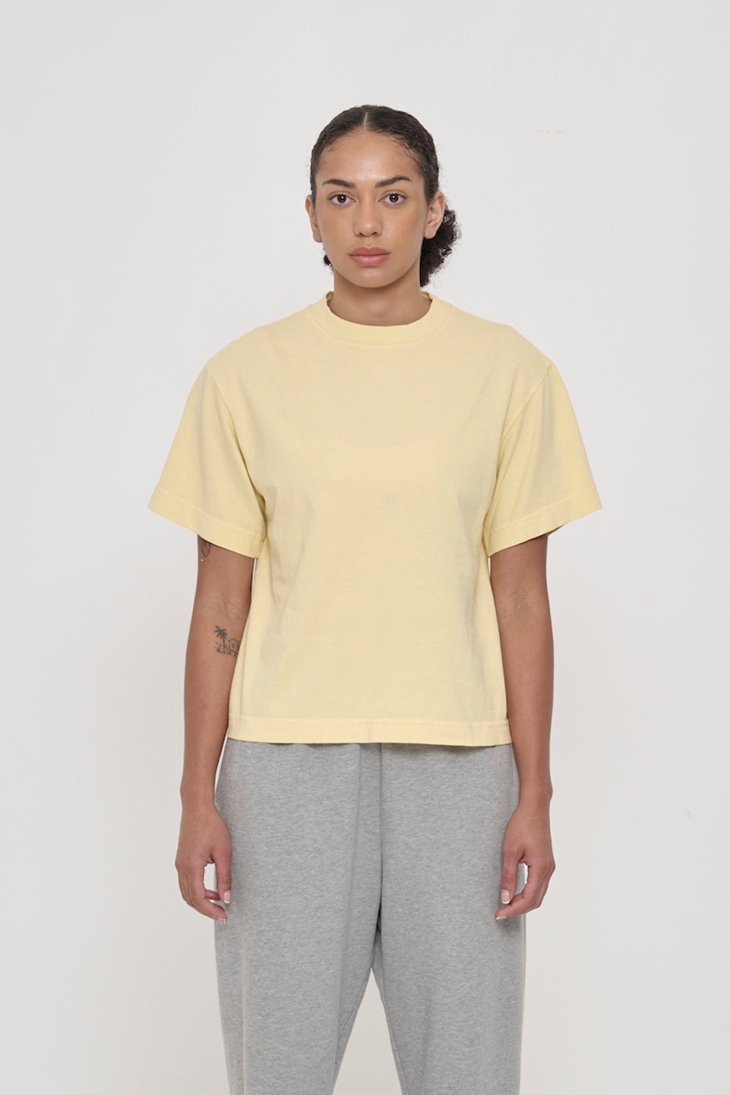 Front view of a 5'8" woman wearing a French Butter Boxier Trash Tee in size XS. Hem at upper-middle hip.