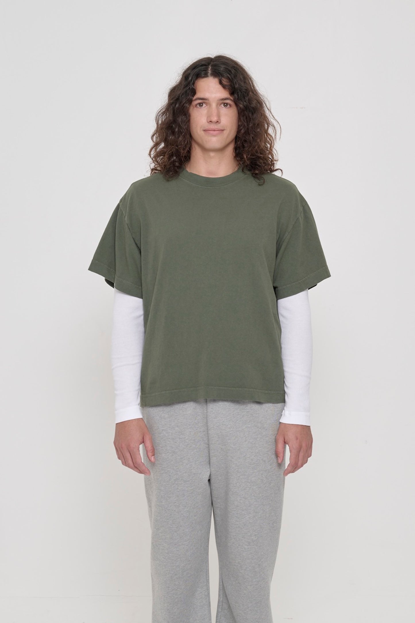 Front view of a 6' person wearing a Pine Boxier Trash Tee in size M. Hem at middle hip.