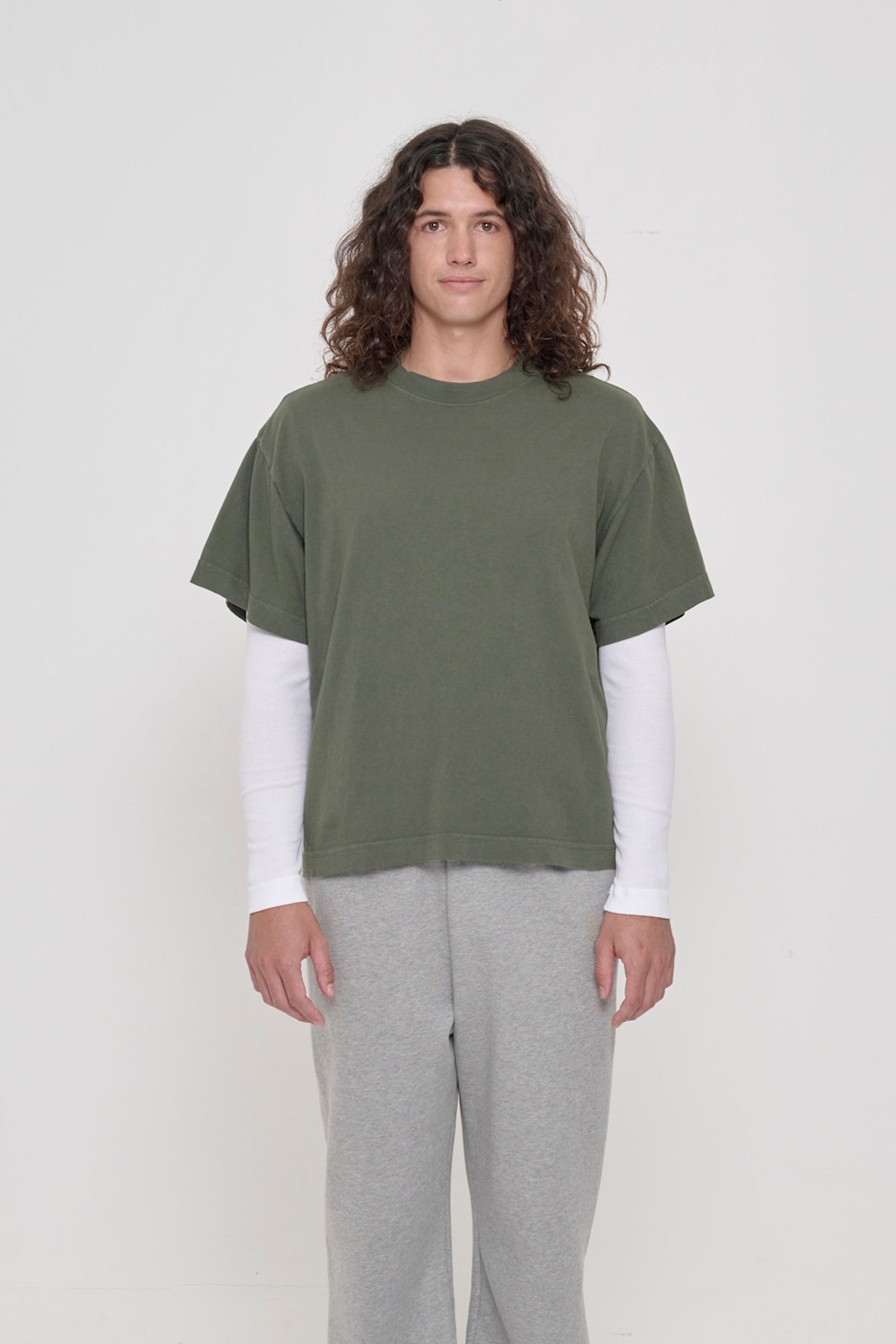 Front view of a 6' person wearing a Pine Boxier Trash Tee in size M. Hem at middle hip.