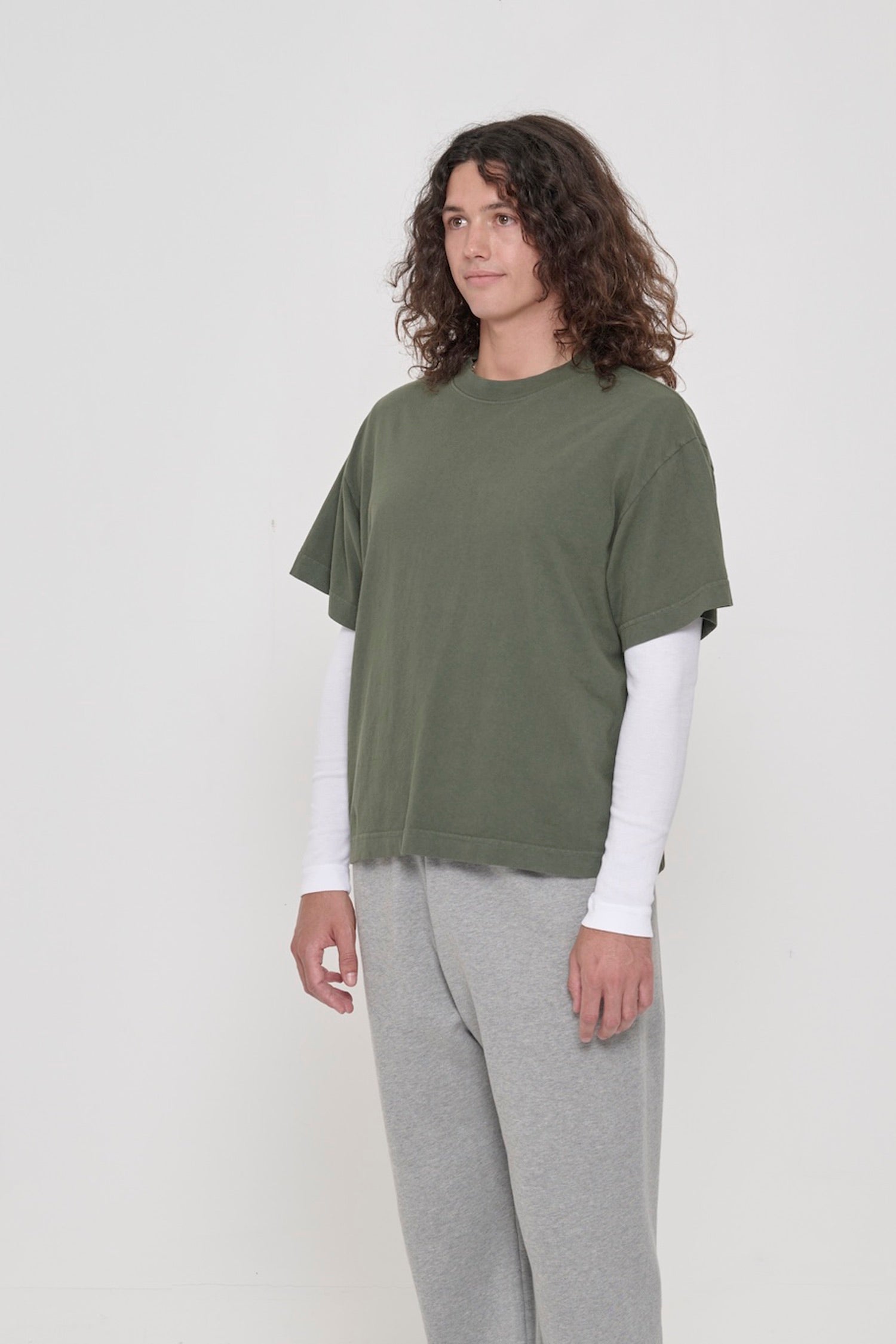 45-degree front view of a person in a Pine Boxier Trash Tee showing no side seams.