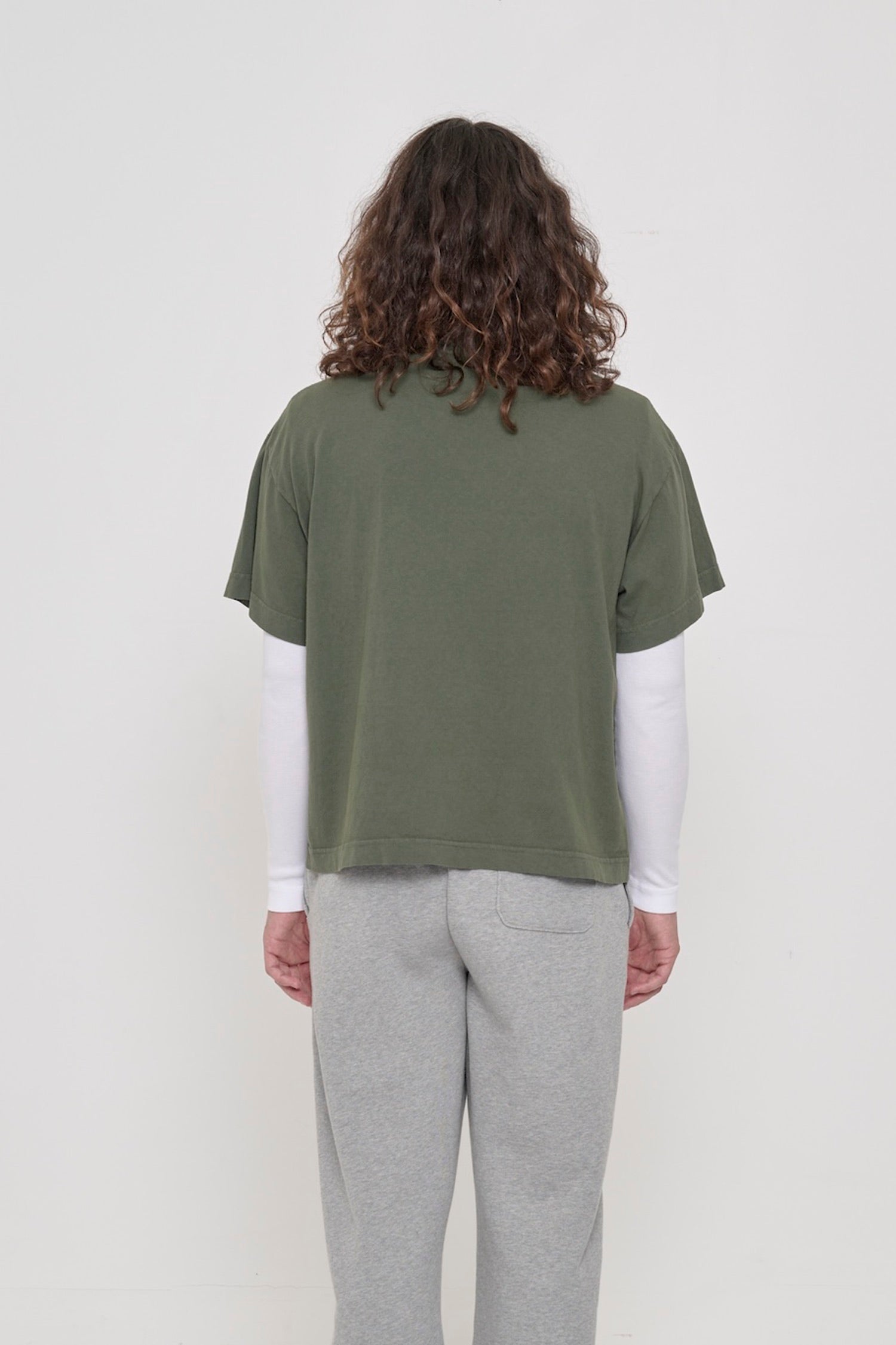 Back view: a person in a Pine Boxier Trash Tee showing fabric drape and relaxed fit throughout.