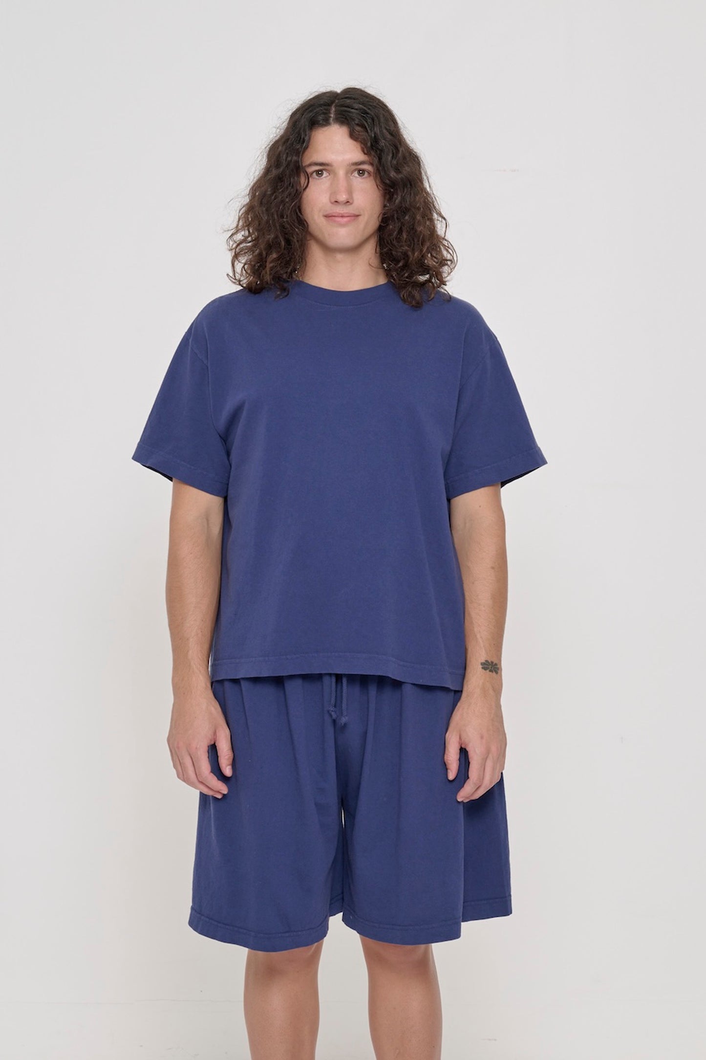 Front view of a 6' person wearing a Washed Navy Boxier Trash Tee in size M. Hem at lower-middle hip.