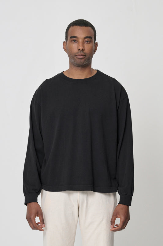 6'2" man in XL Black Long Sleeve Boxier Trash Tee; shirt hem at mid-hip, arms at sides.