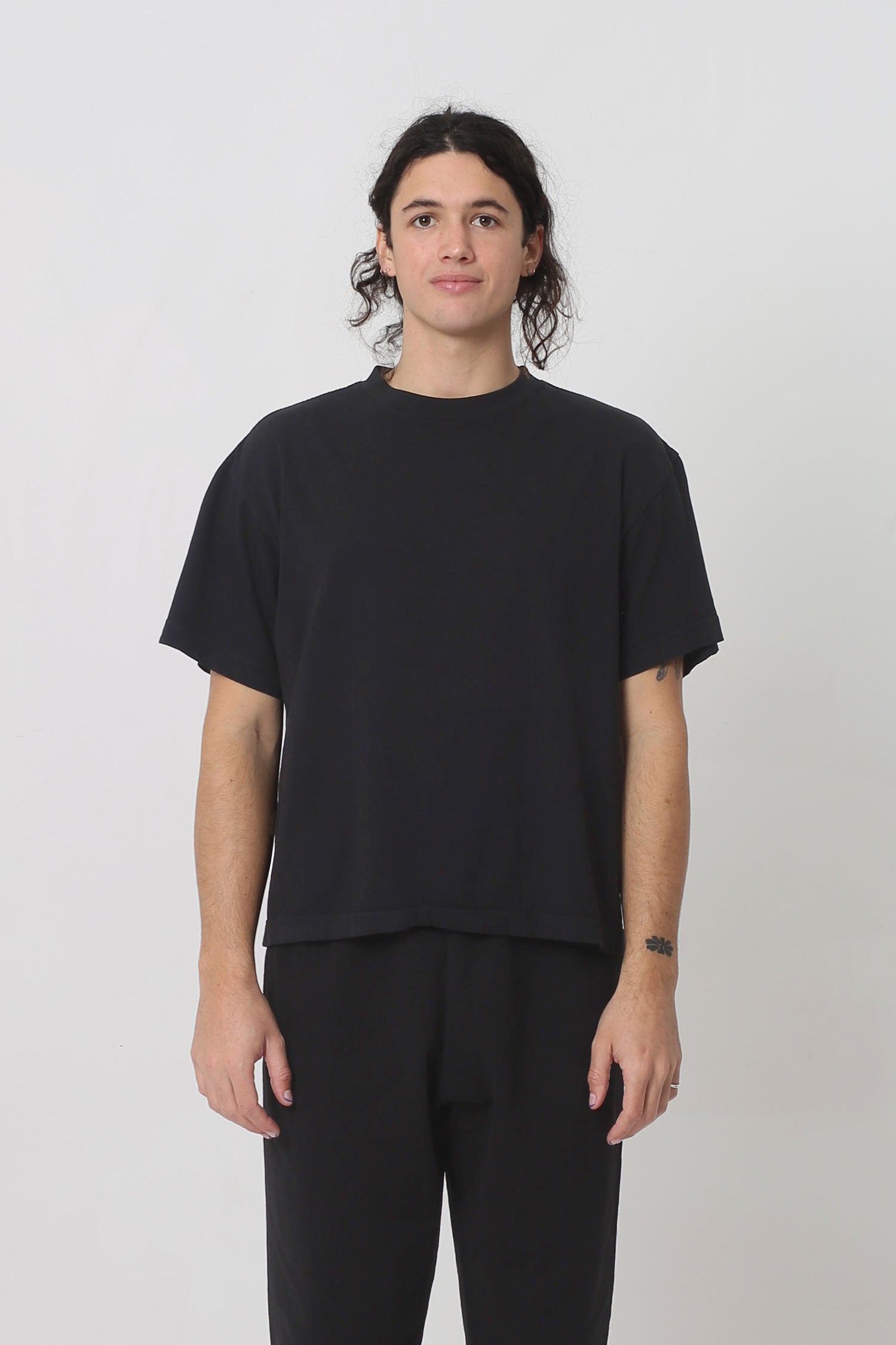 6' tall person in Black Boxier Trash Tee in size M. Bottom hem ends at mid-hip.