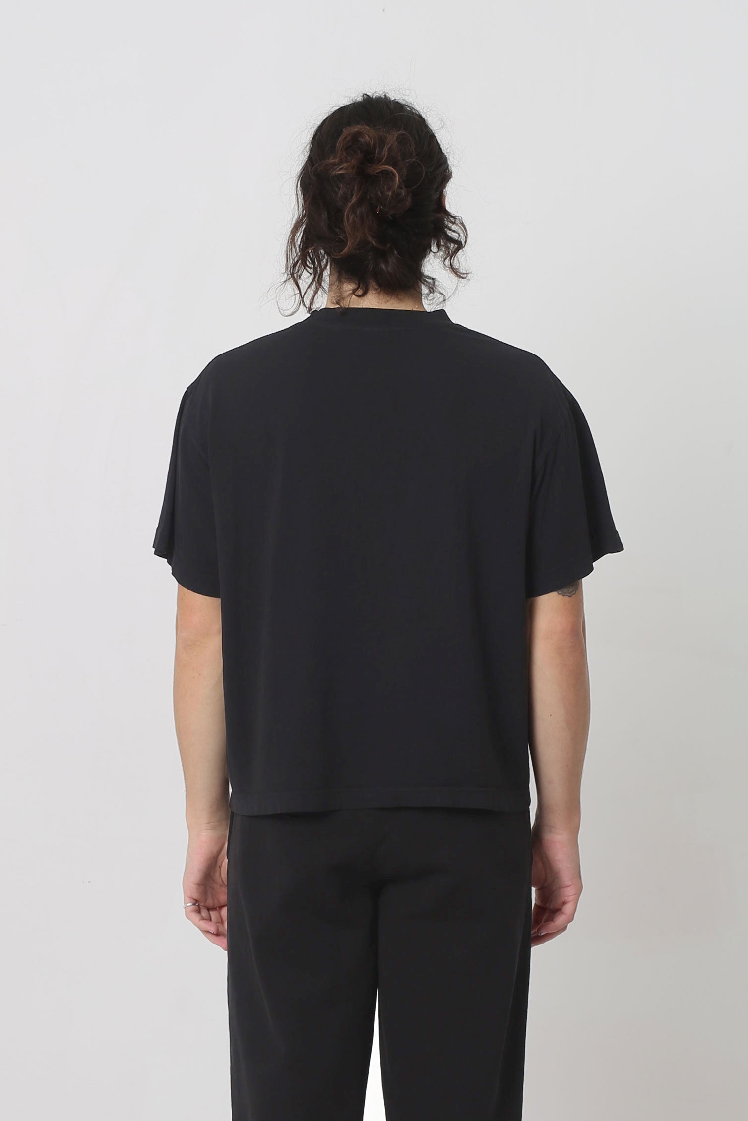 Back view showing fabric drape and relaxed fit throughout.