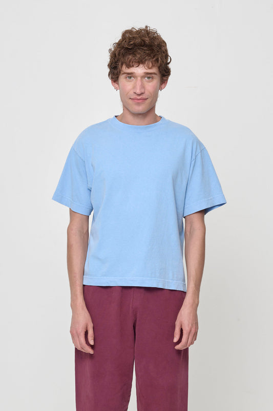 Front view of a 5'11" person wearing Cielo (light blue) Boxier Trash Tee in size S. Bottom hem cropped to the upper hip.