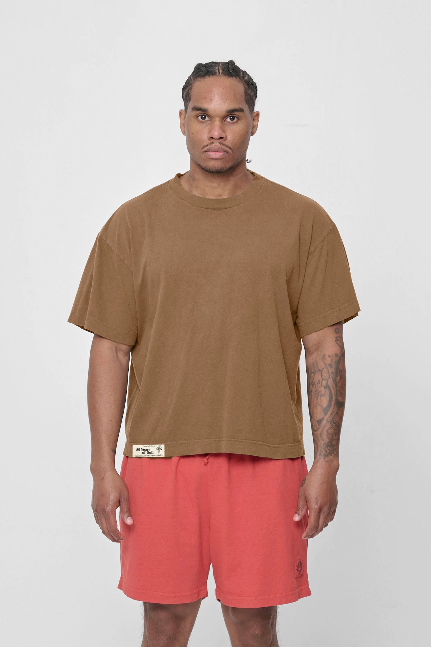 A 6' man in a size L Boxier Trash Tee. Hem at middle hip.