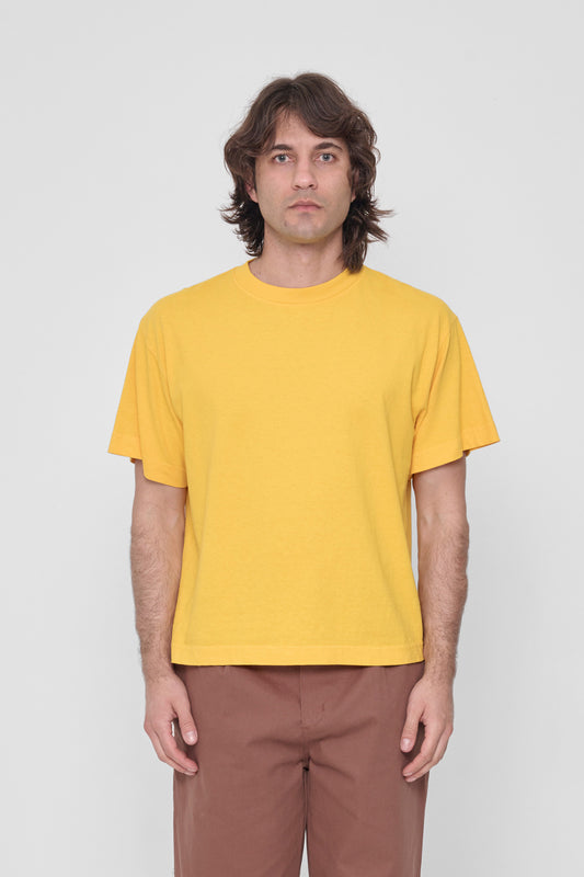 A 6'2" man in a size M Everybody Yellow Boxier Trash Tee. Bottom hem at middle hip.