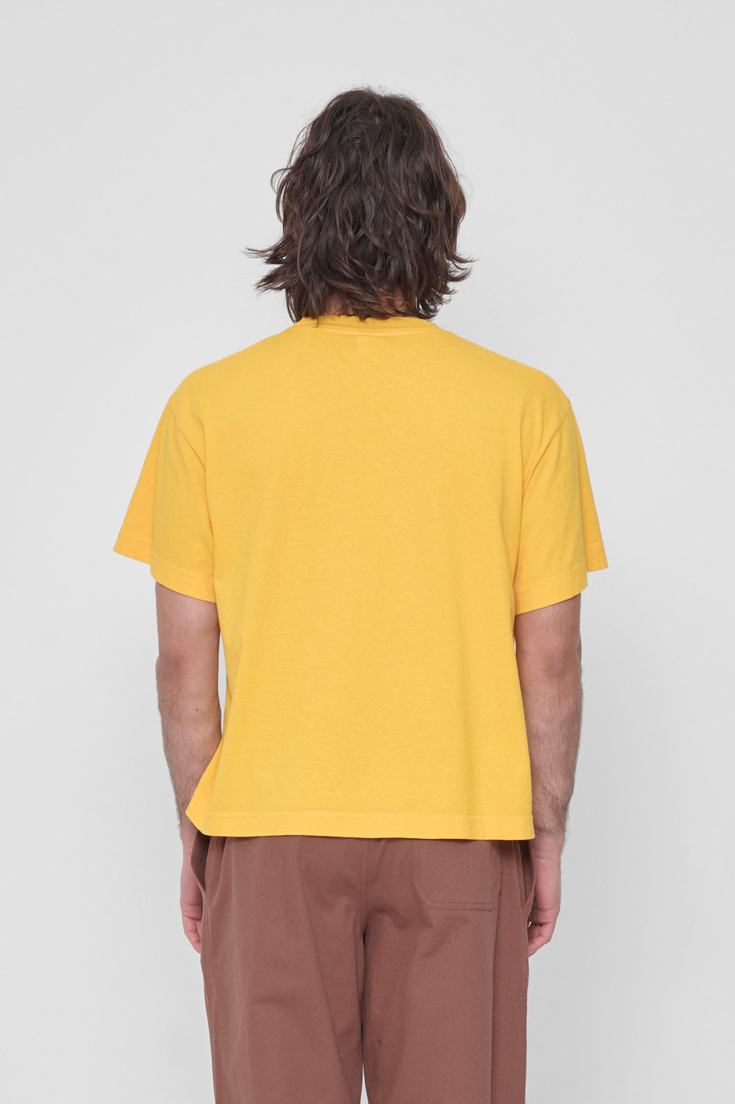 Back view showing fabric drape and relaxed fit throughout.