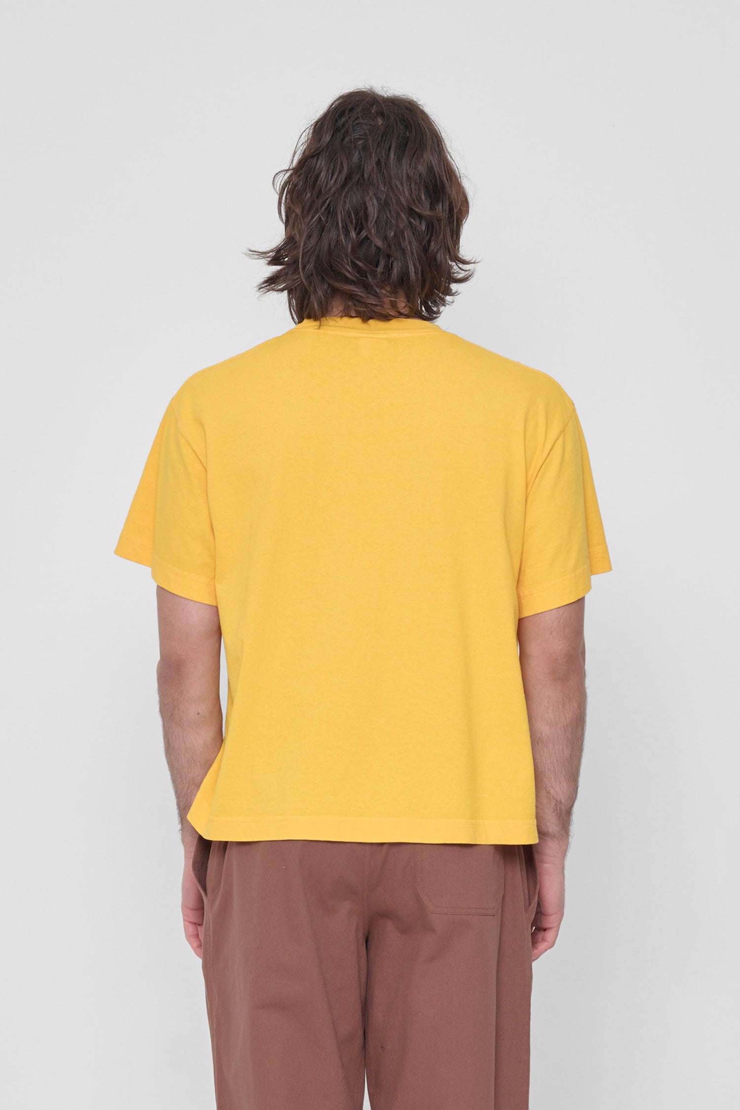 Back view showing fabric drape and relaxed fit throughout.