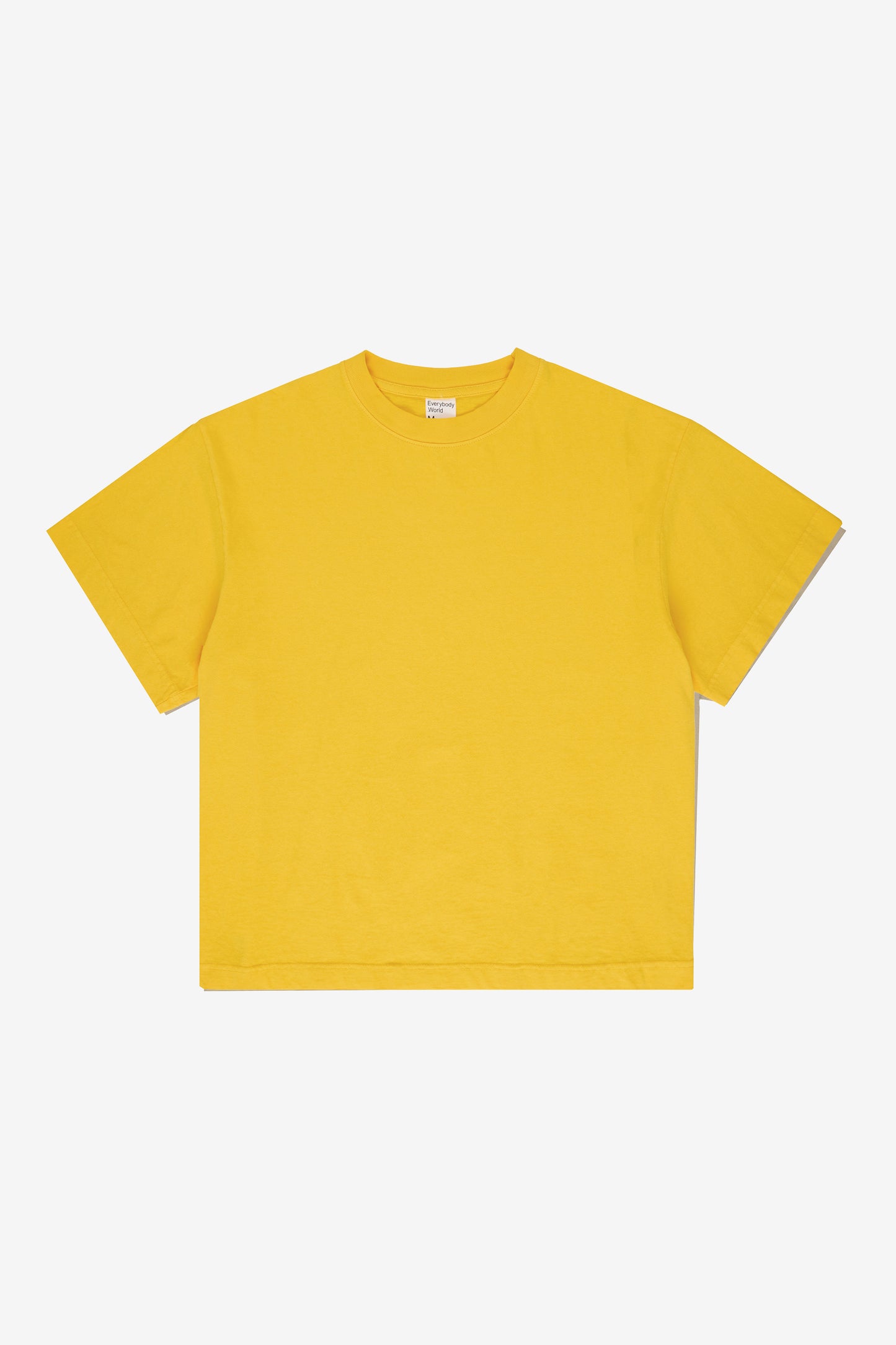 Flat lay showing the square-like boxy cut of the t-shirt.