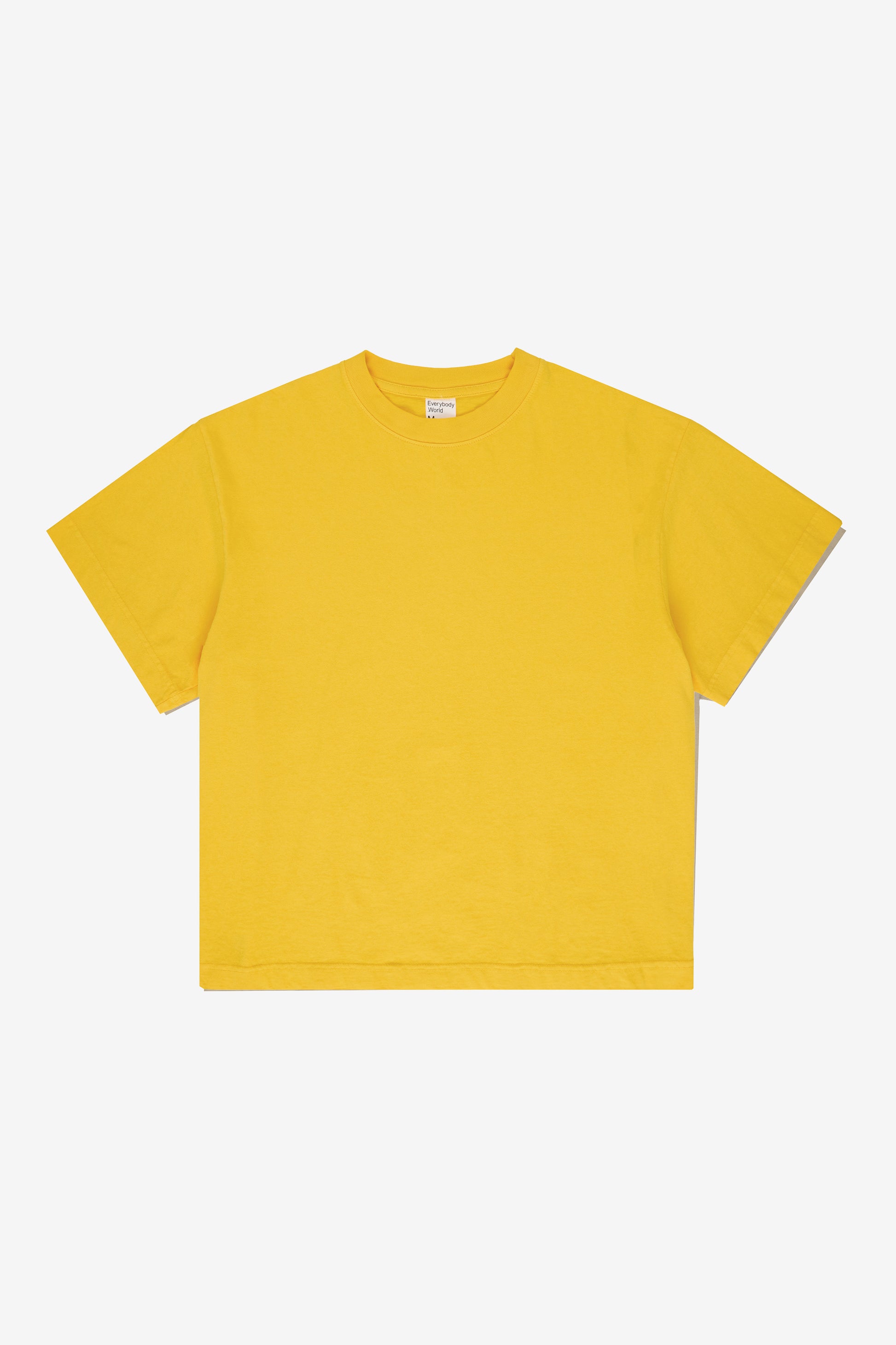 Flat lay showing the square-like boxy cut of the t-shirt.