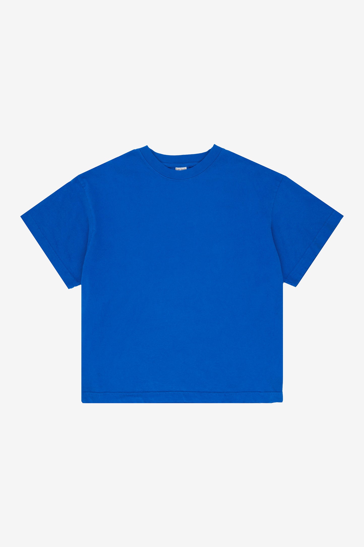 Flat lay showing the square-like boxy cut of the t-shirt.