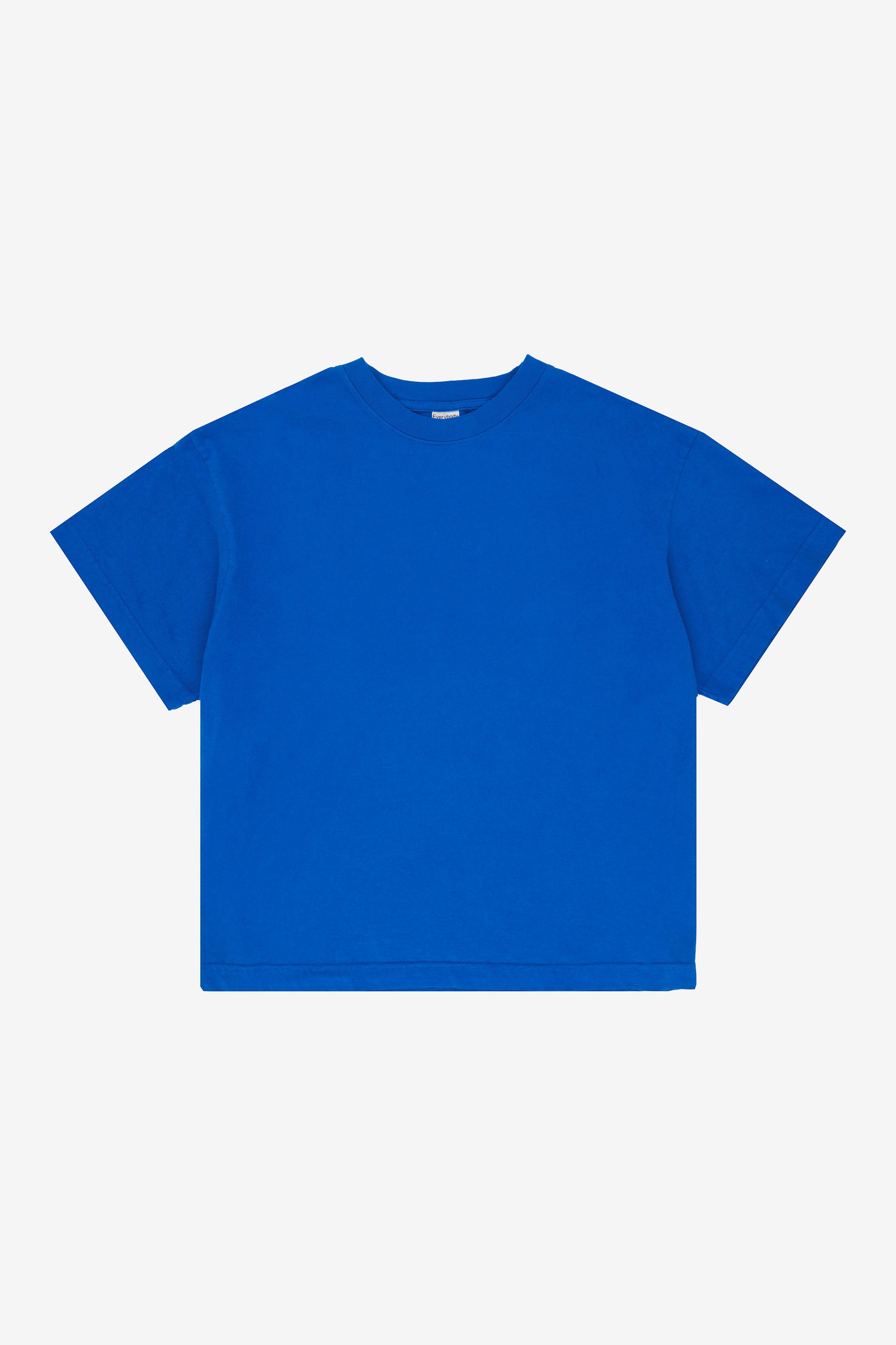 Flat lay showing the square-like boxy cut of the t-shirt.