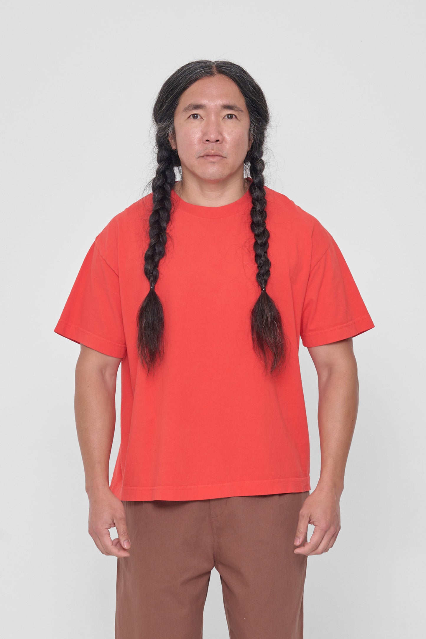 A 5'11" man in a size L Lava red Boxier Trash Tee. Bottom hem at the middle hip.