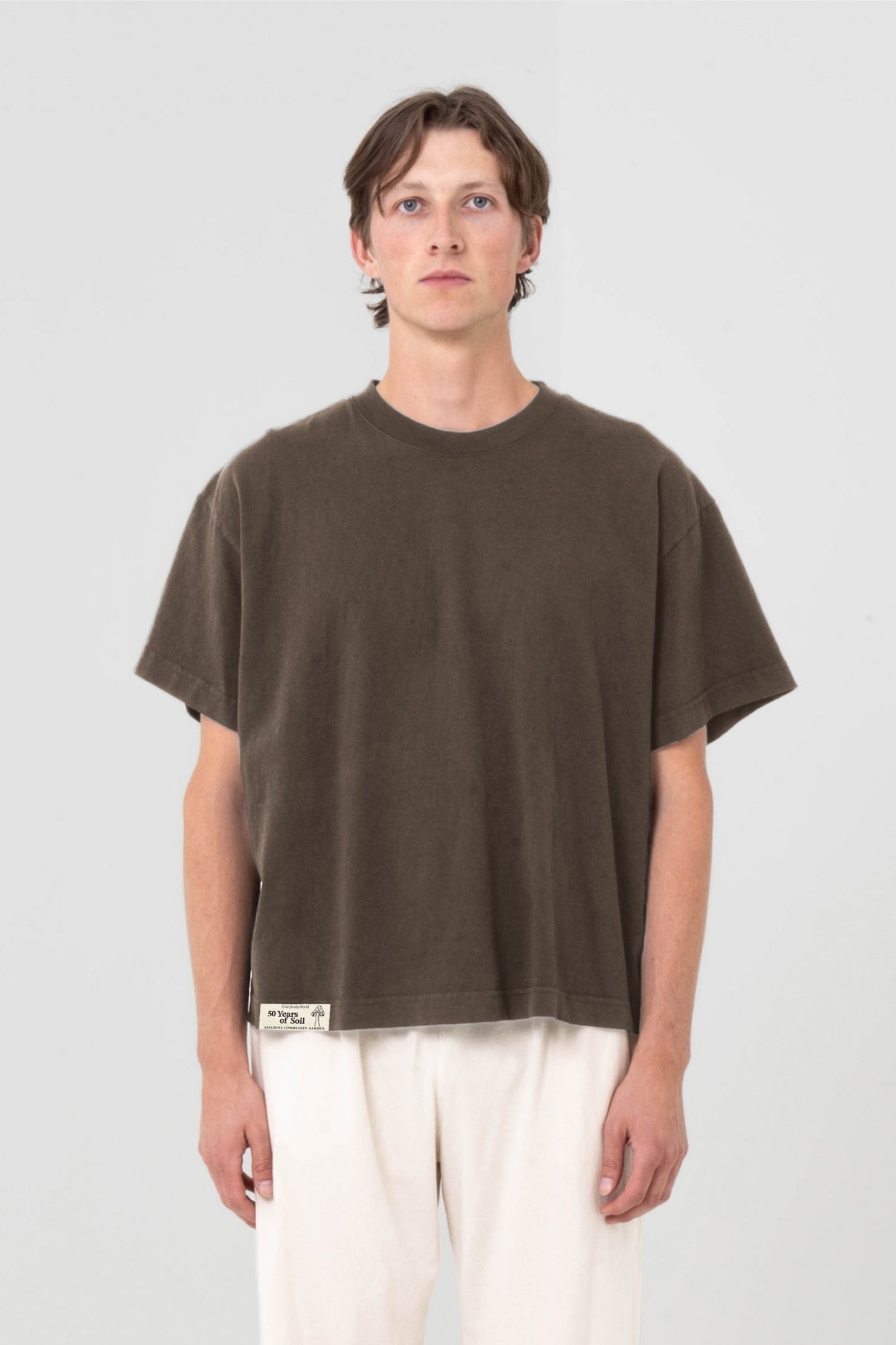 A 6' man in a size L Boxier Trash Tee. Hem at middle hip.